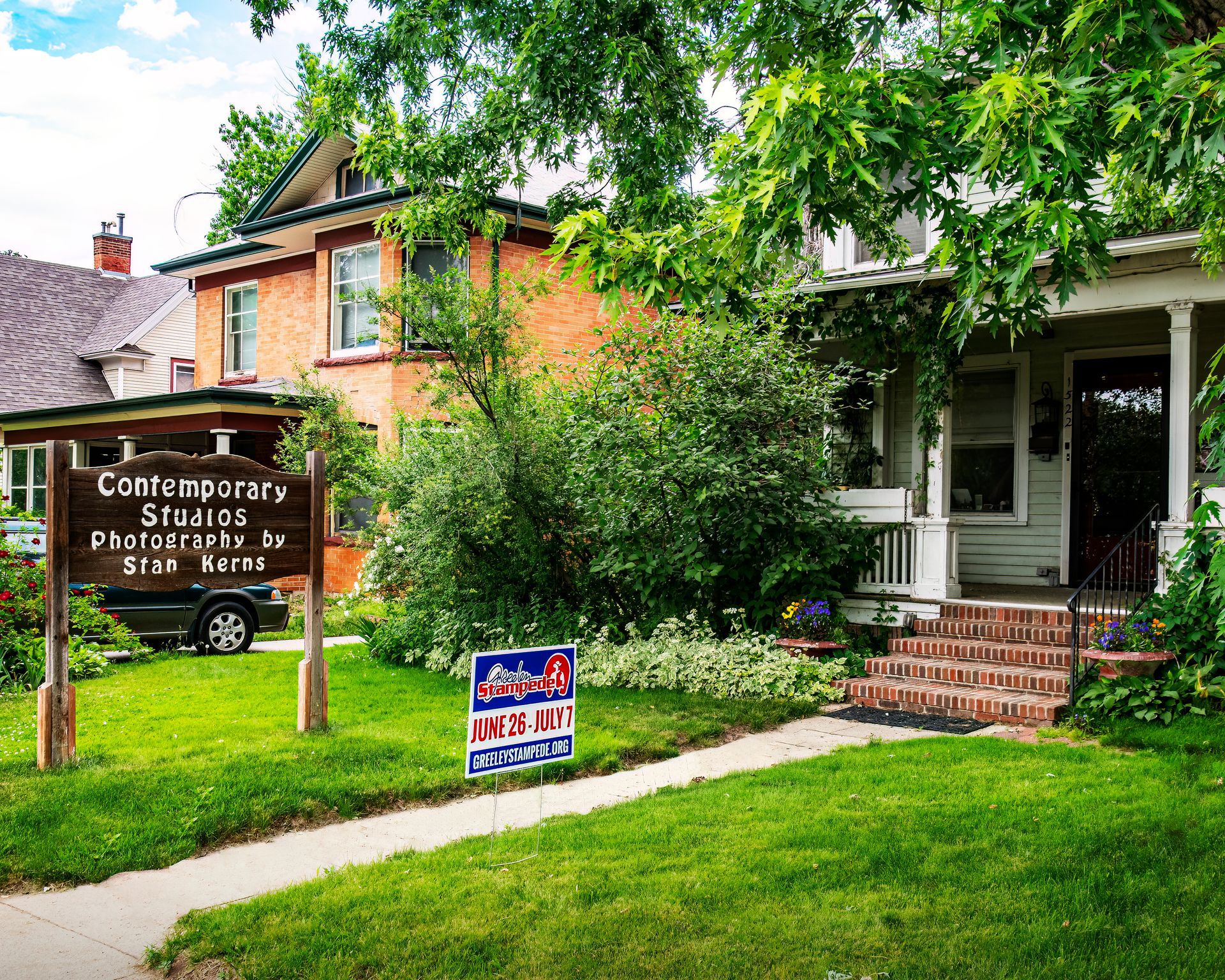 A house with a sign that says contemporary studios on it