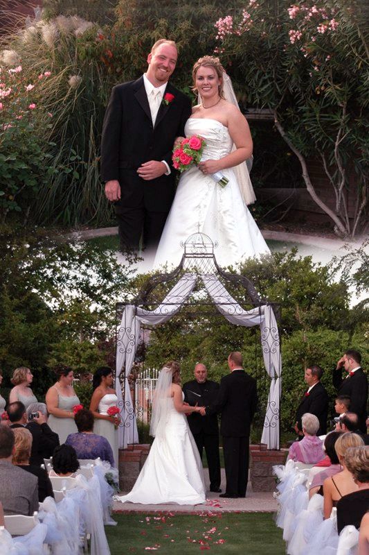 A bride and groom are posing for a picture at their wedding