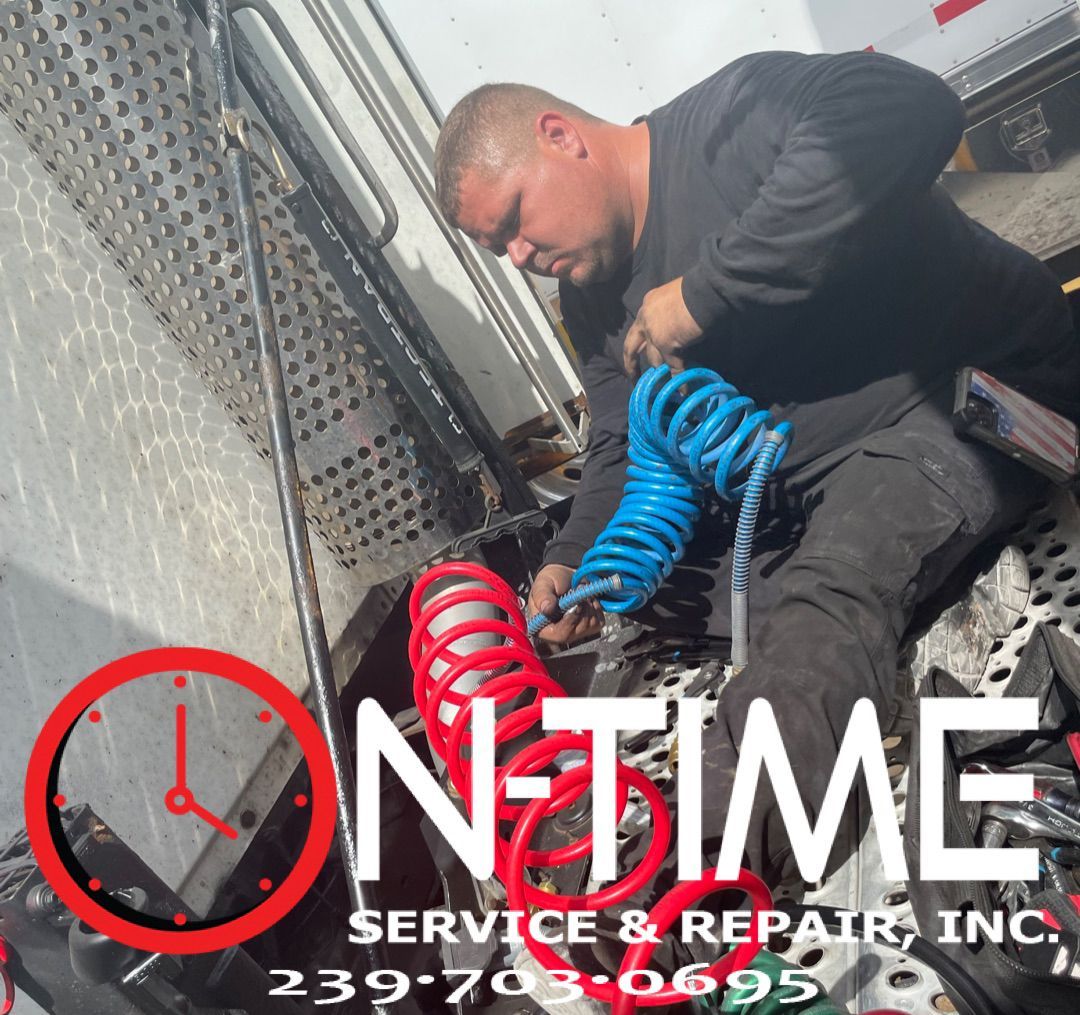A man is working on a truck with the words on time service & repair inc.