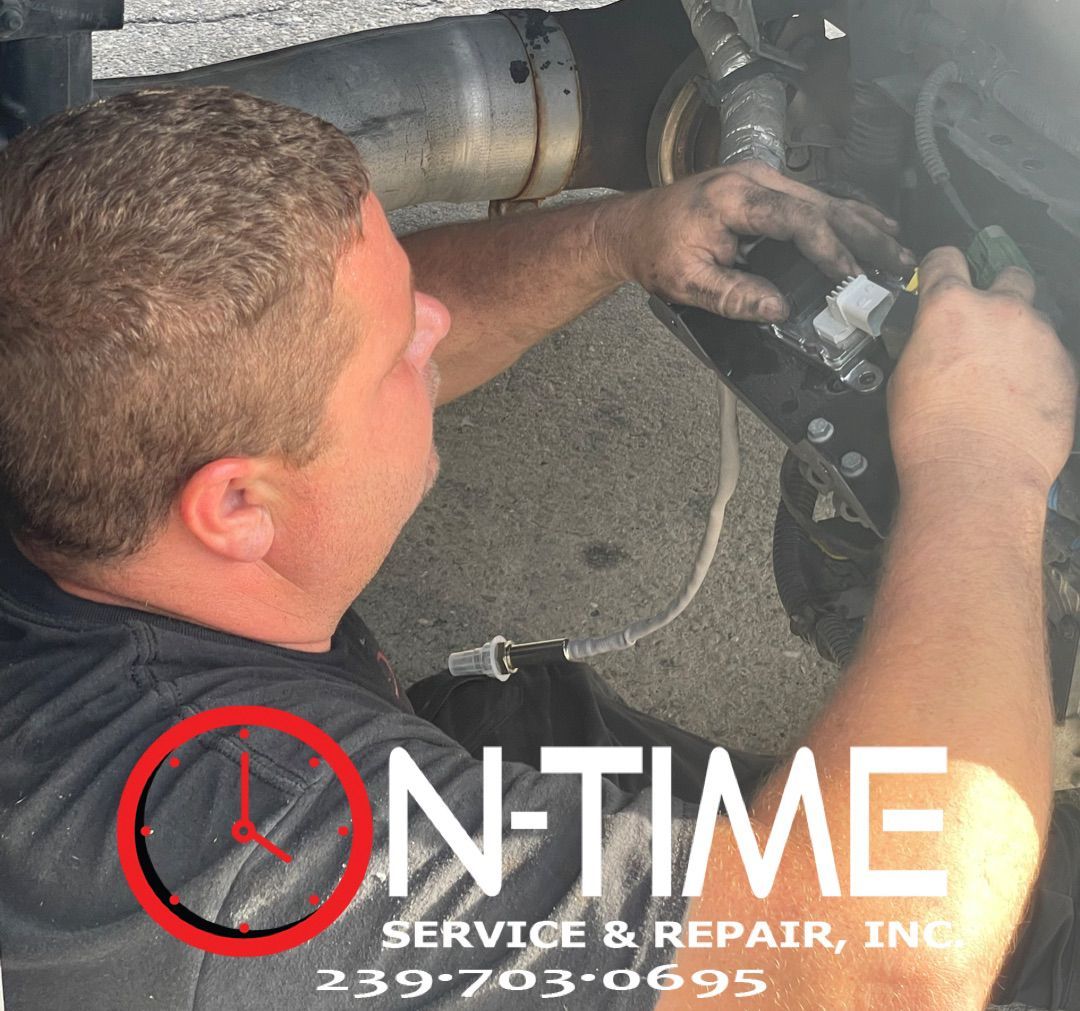 A man is working on a vehicle with the words on time service & repair inc.