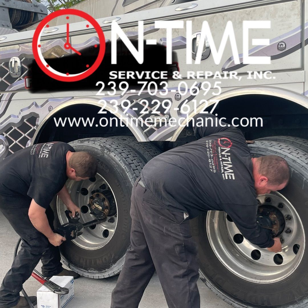 Two men are working on a truck that says on time service and repair inc.