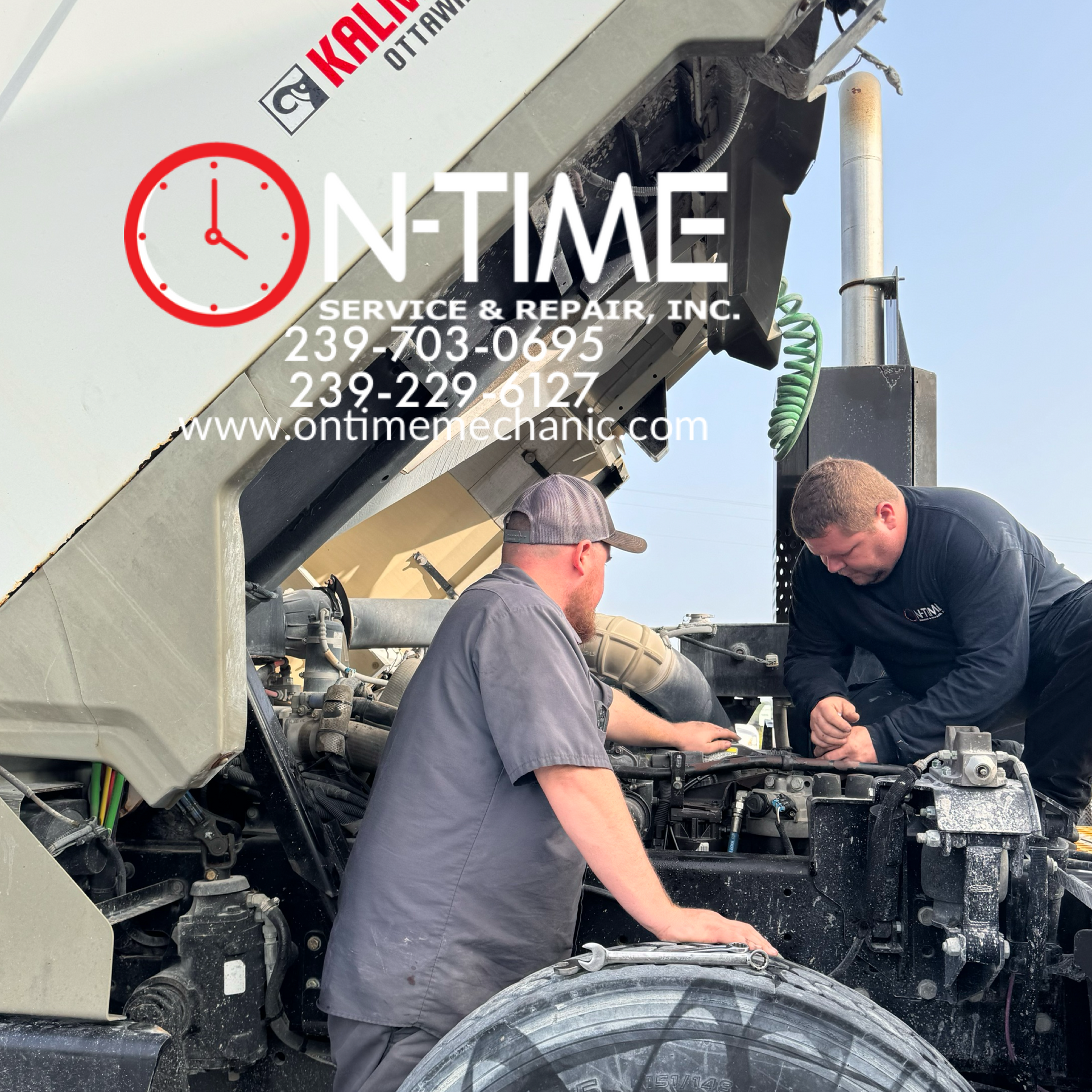 Two men are working on a truck that says on time service & repair inc.
