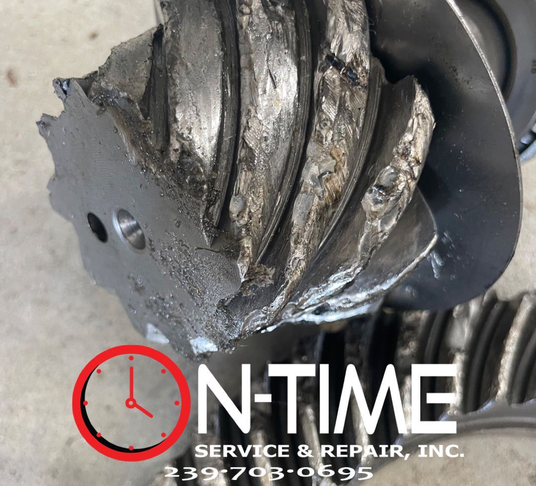 A close up of a gear that says on time service & repair inc.