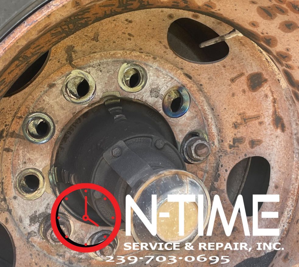 A close up of a wheel with the words on time service & repair inc.