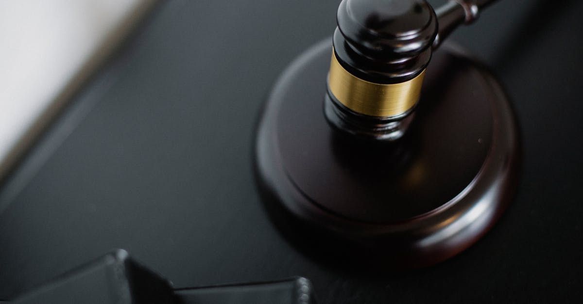 A judge 's gavel is sitting on top of a black table.