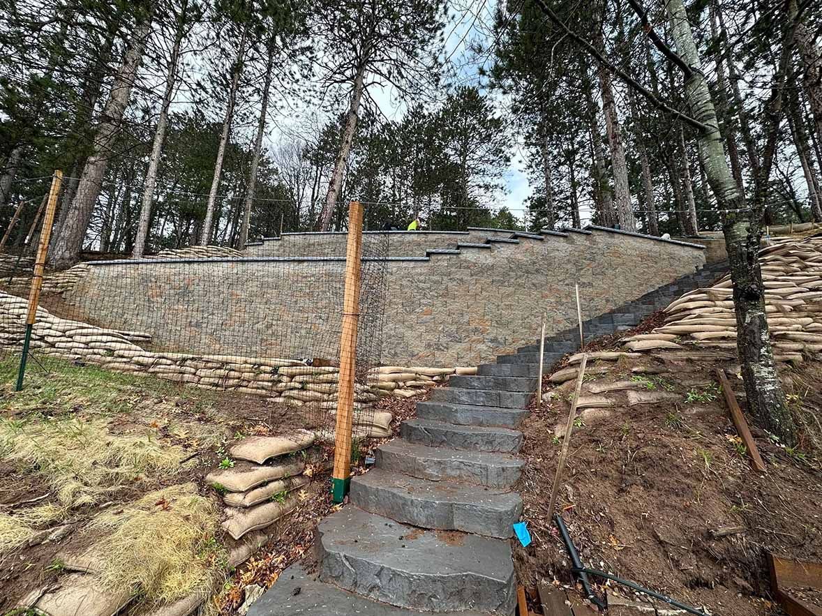 Stone steps leading up a hillside with a retaining wall