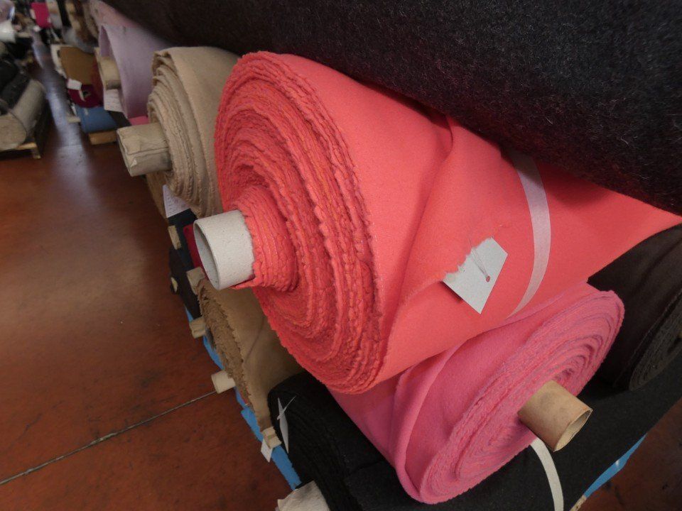 rolls of winter fabrics of various colours