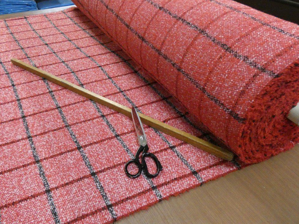 roll of red winter fabric with black stripes