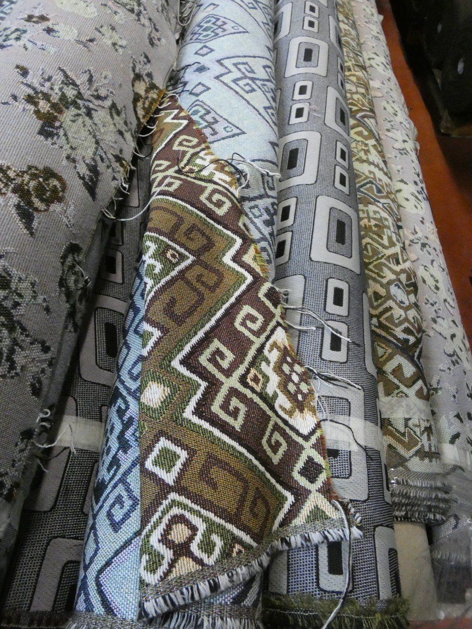 rolls of summer fabrics with various patterns
