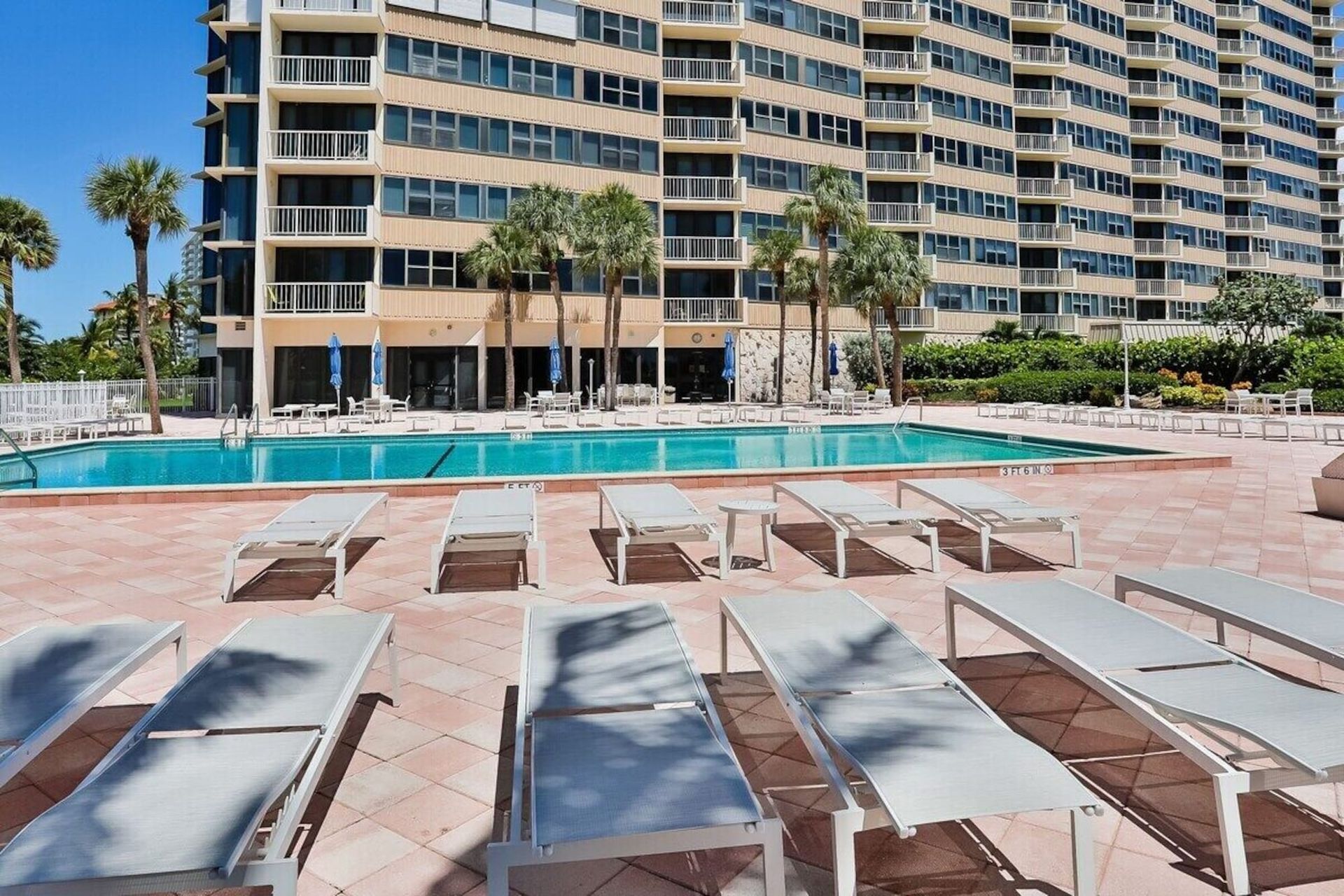 A large building with a swimming pool in front of it