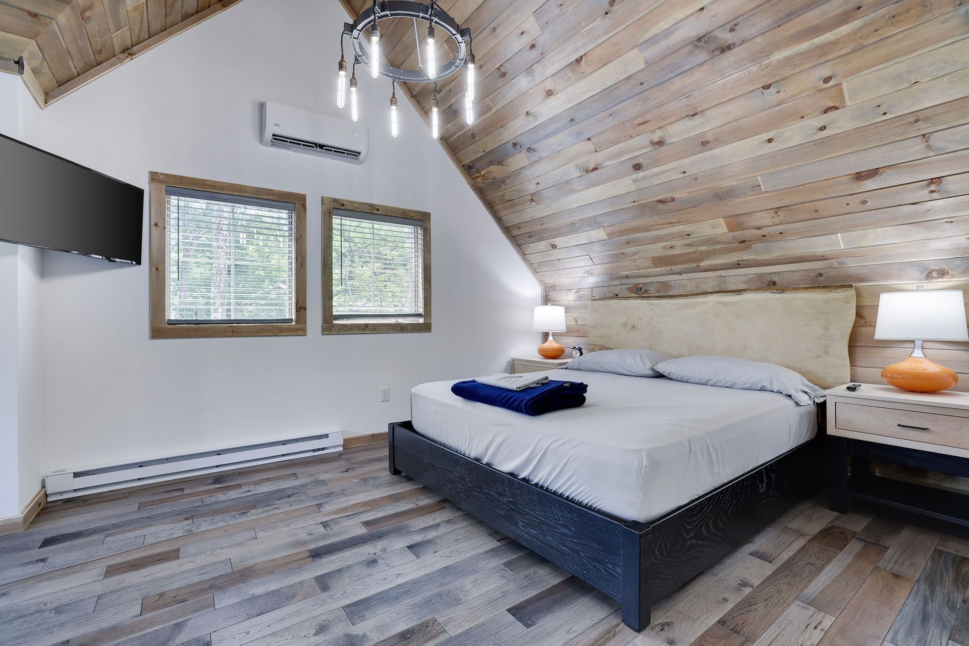 A bedroom with a king size bed and a flat screen tv.