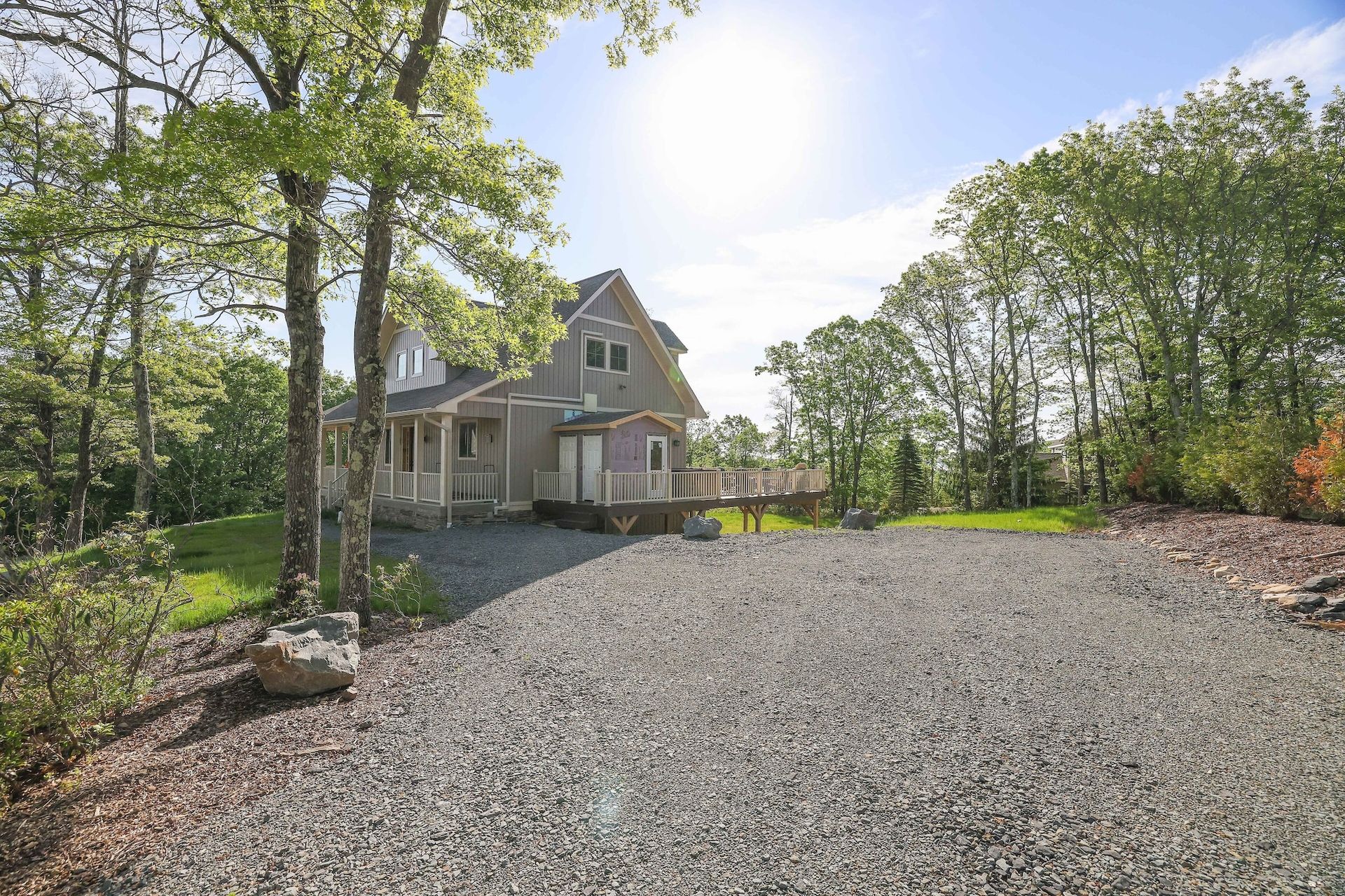A house with a gravel driveway in front of it