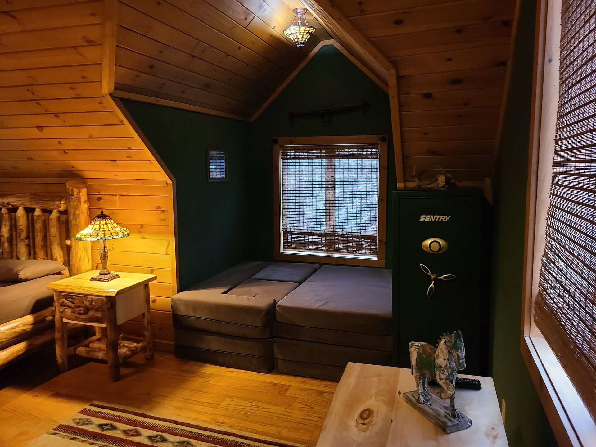 A room with a safe and a bed in it