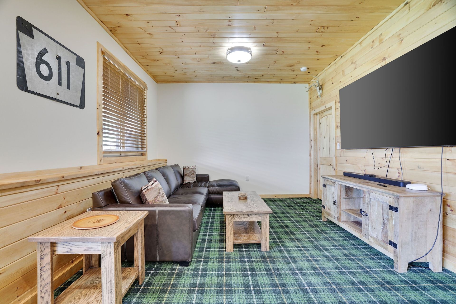 A living room with a couch , table , and television.