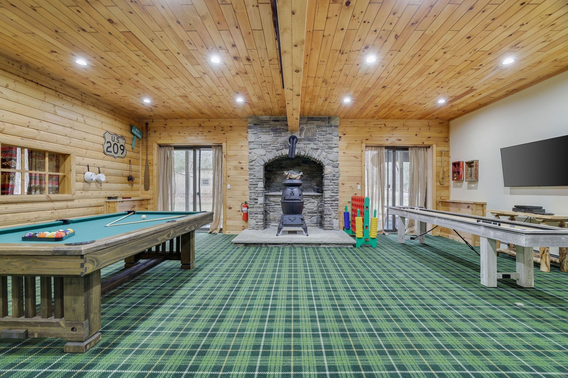 There is a pool table in the middle of the room.