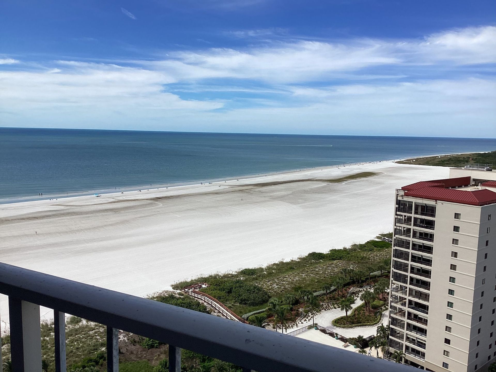 A view of a beach and ocean from a balcony
