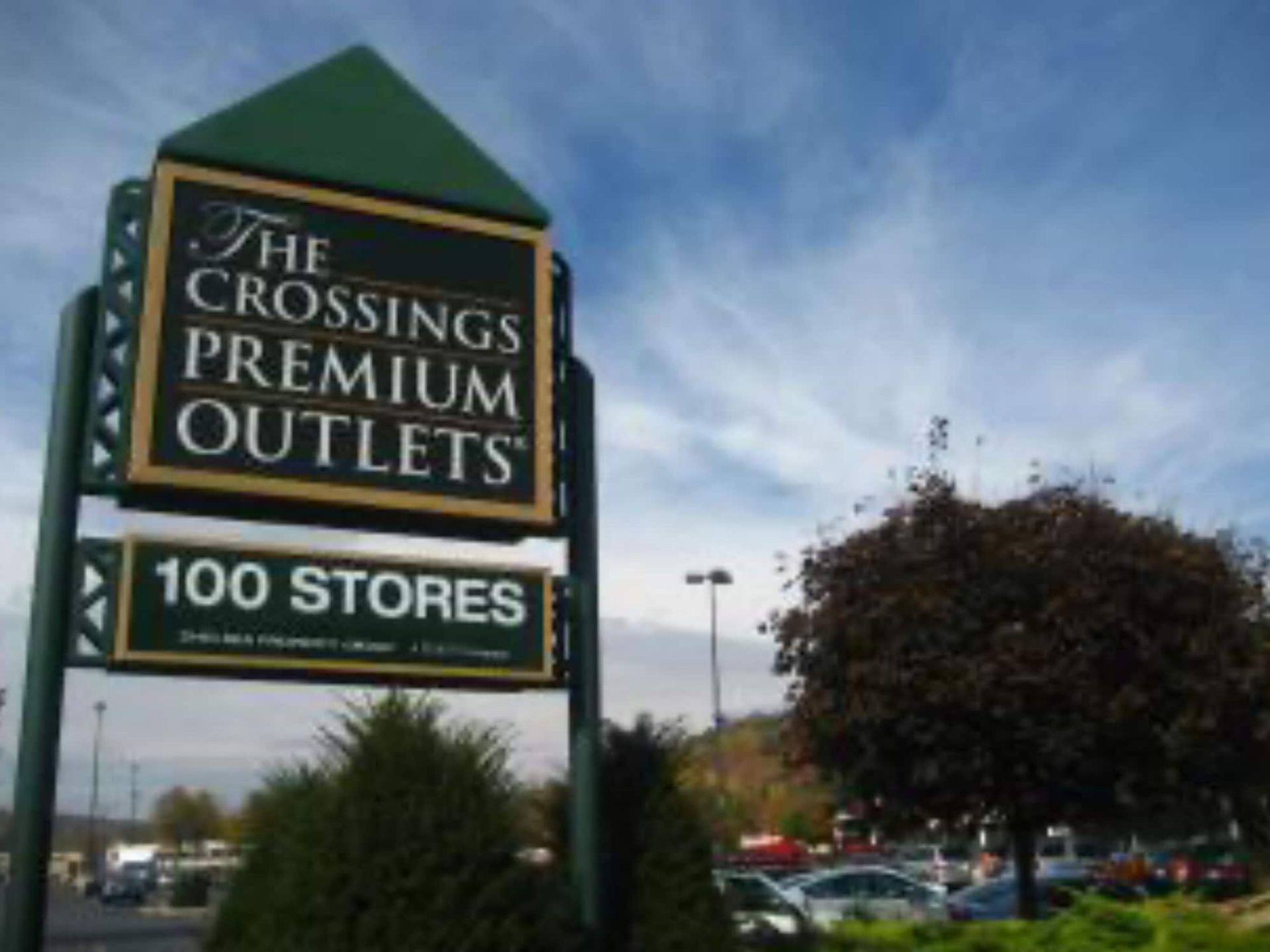 A sign for the crossings premium outlets 100 stores