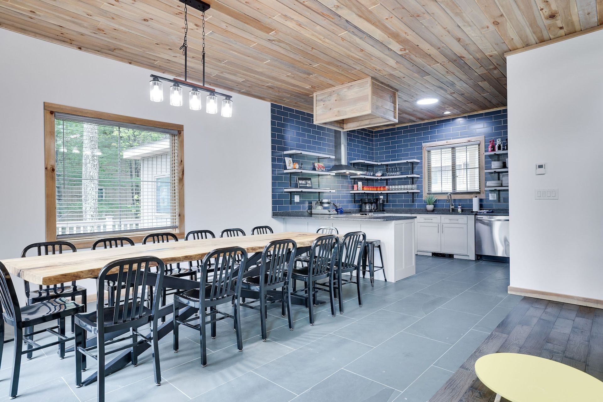 There is a long table and chairs in the middle of the room.