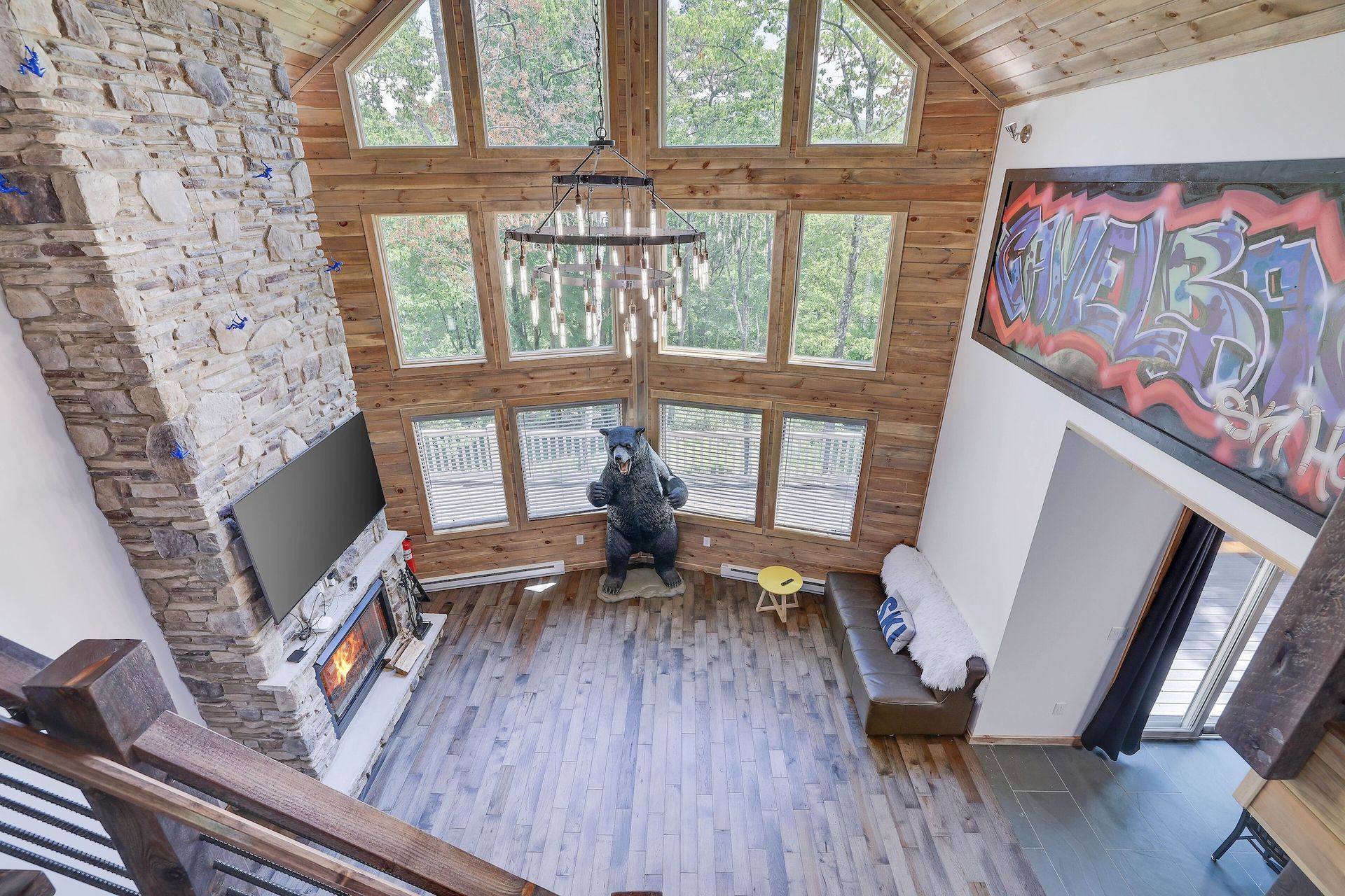 An aerial view of a living room with a fireplace and lots of windows.