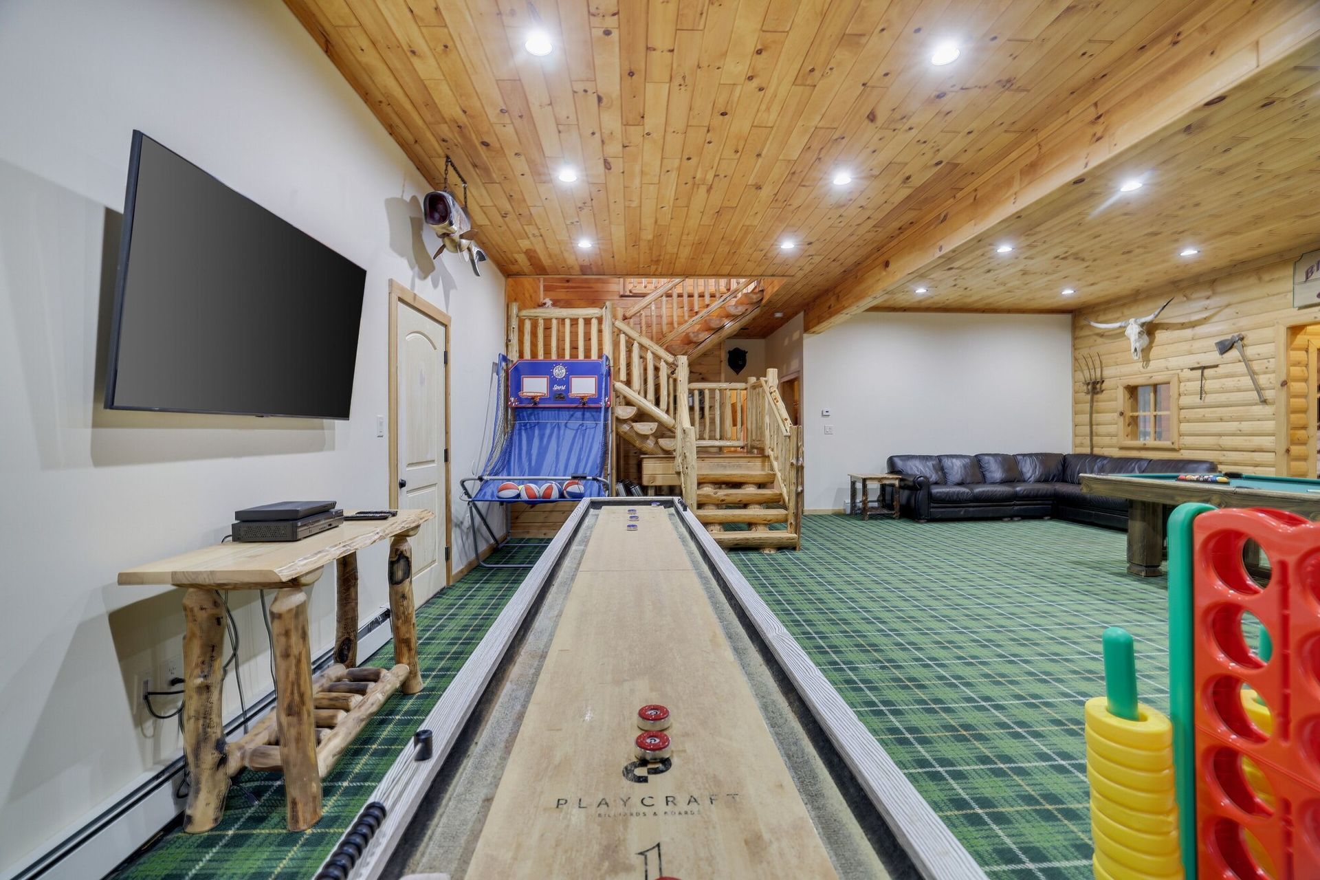 There is a shuffleboard table in the middle of the room.