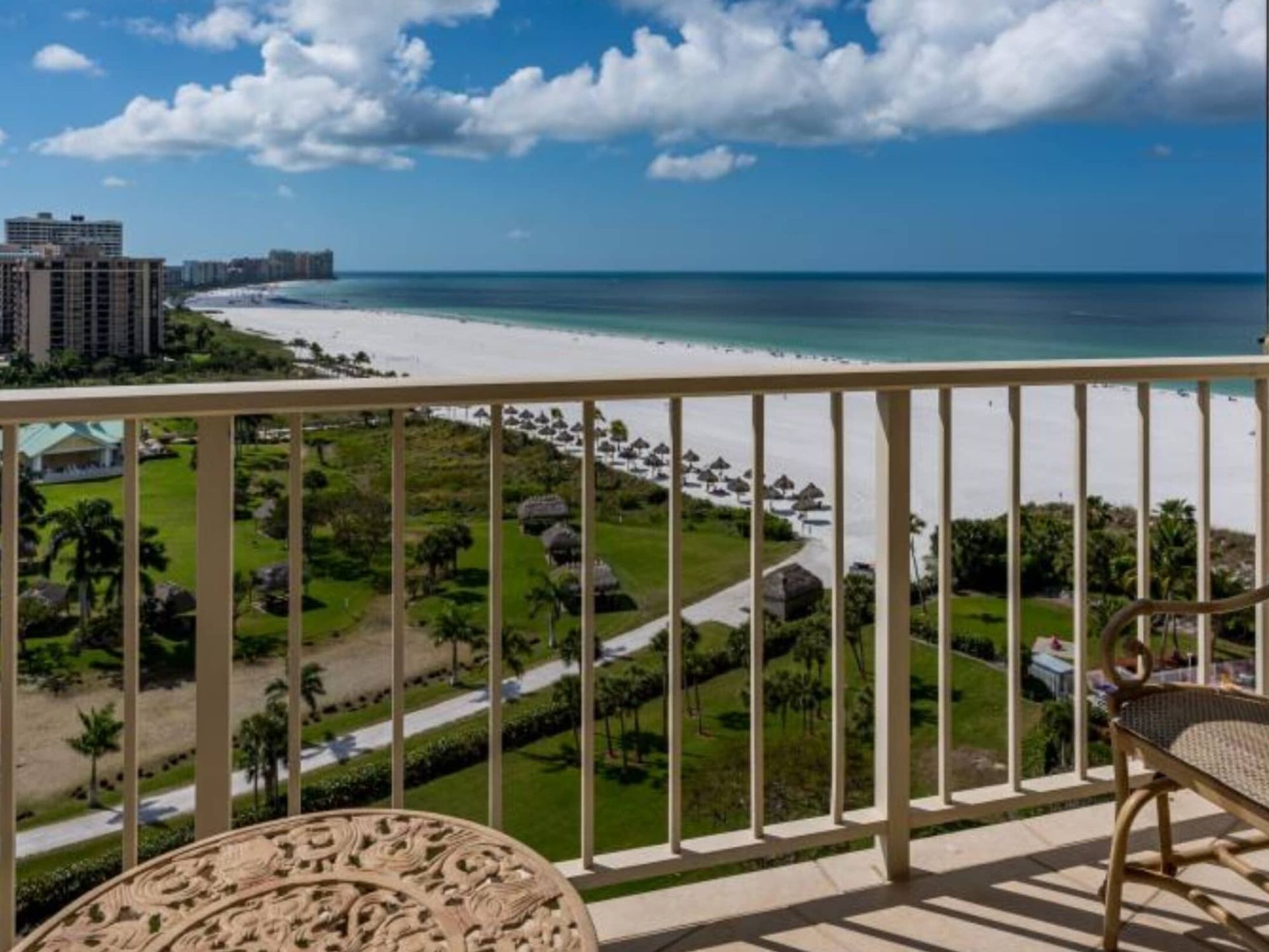 A balcony with a view of the beach and ocean