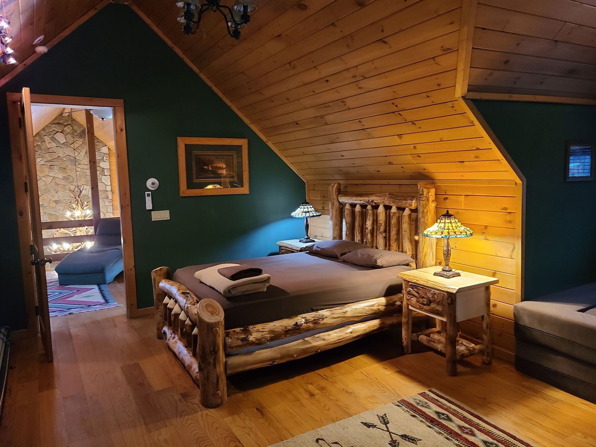 A bedroom with a bed , nightstand , and lamp.