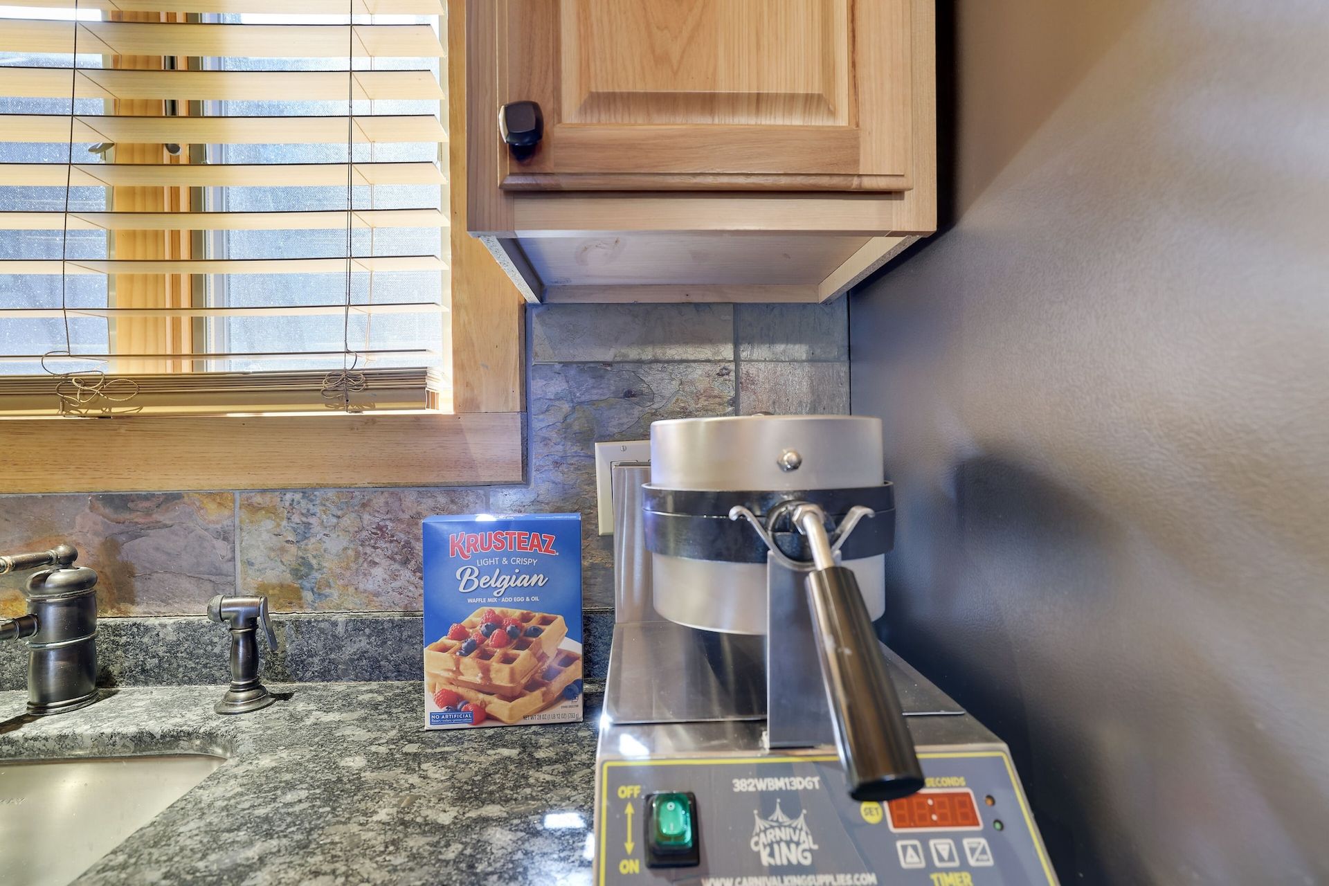 A kitchen counter with a box of cereal and a coffee maker.