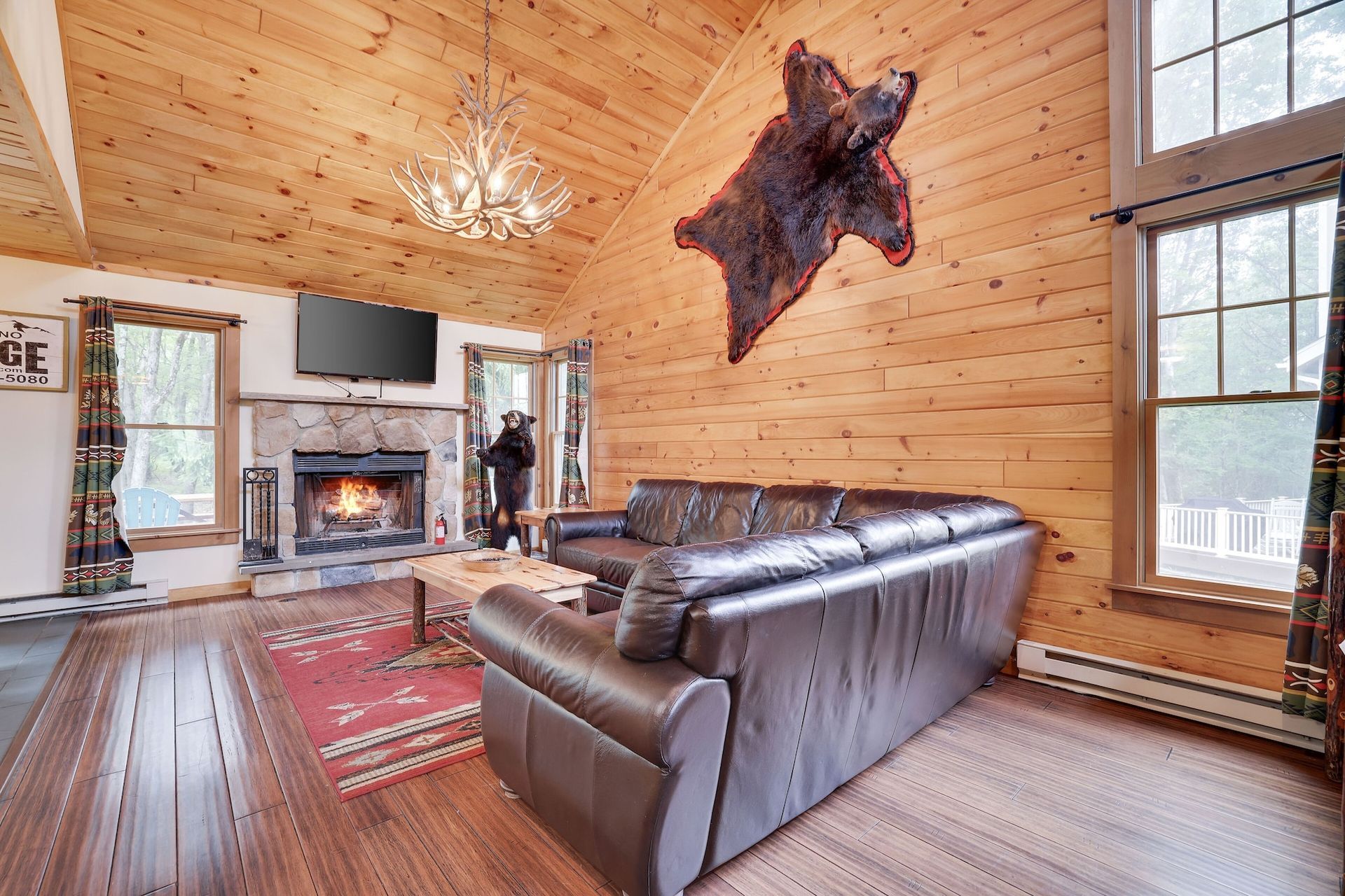 A living room with a couch , fireplace , and television.