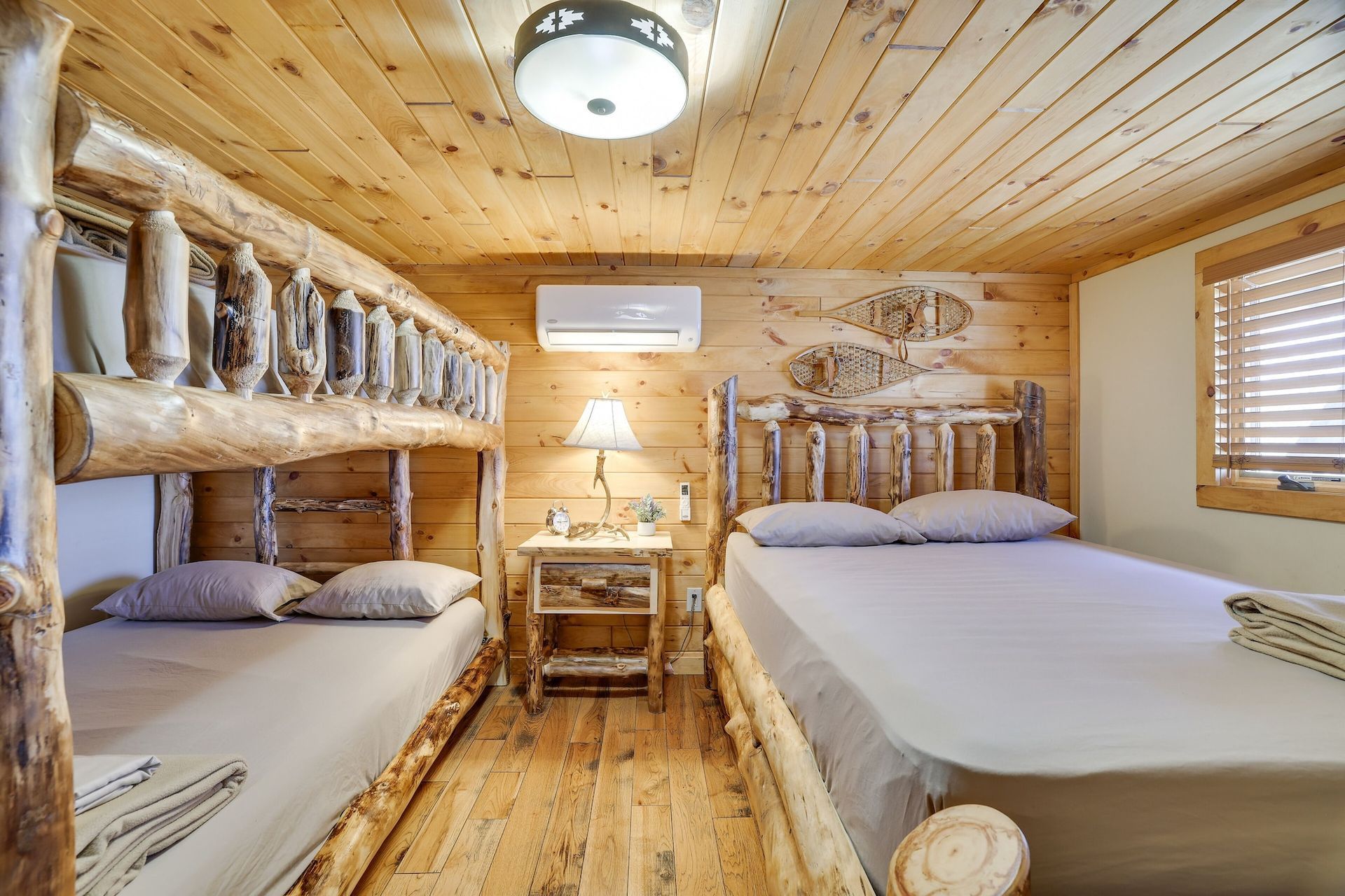 A bedroom with two bunk beds and a large bed.