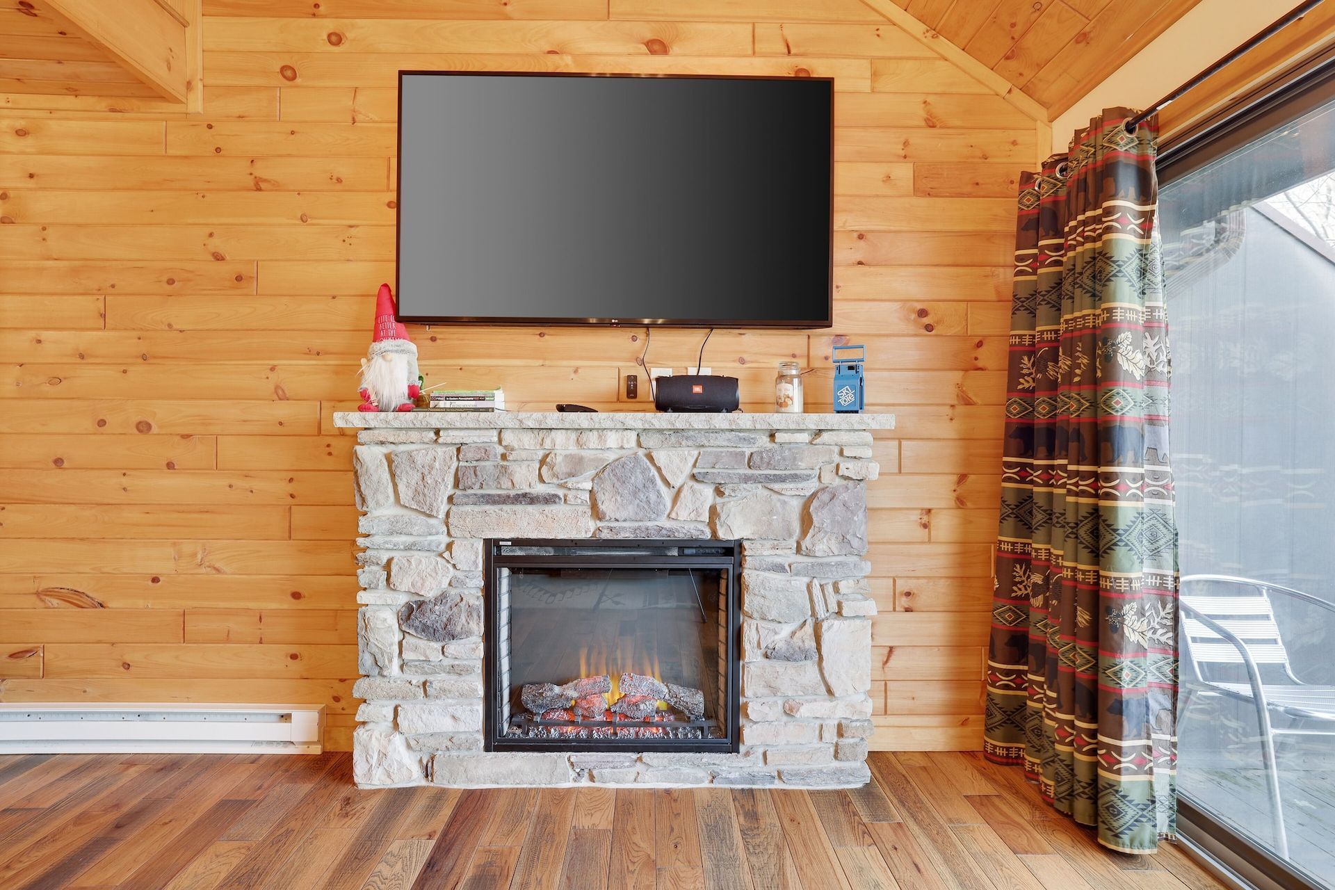 A living room with a fireplace and a flat screen tv.