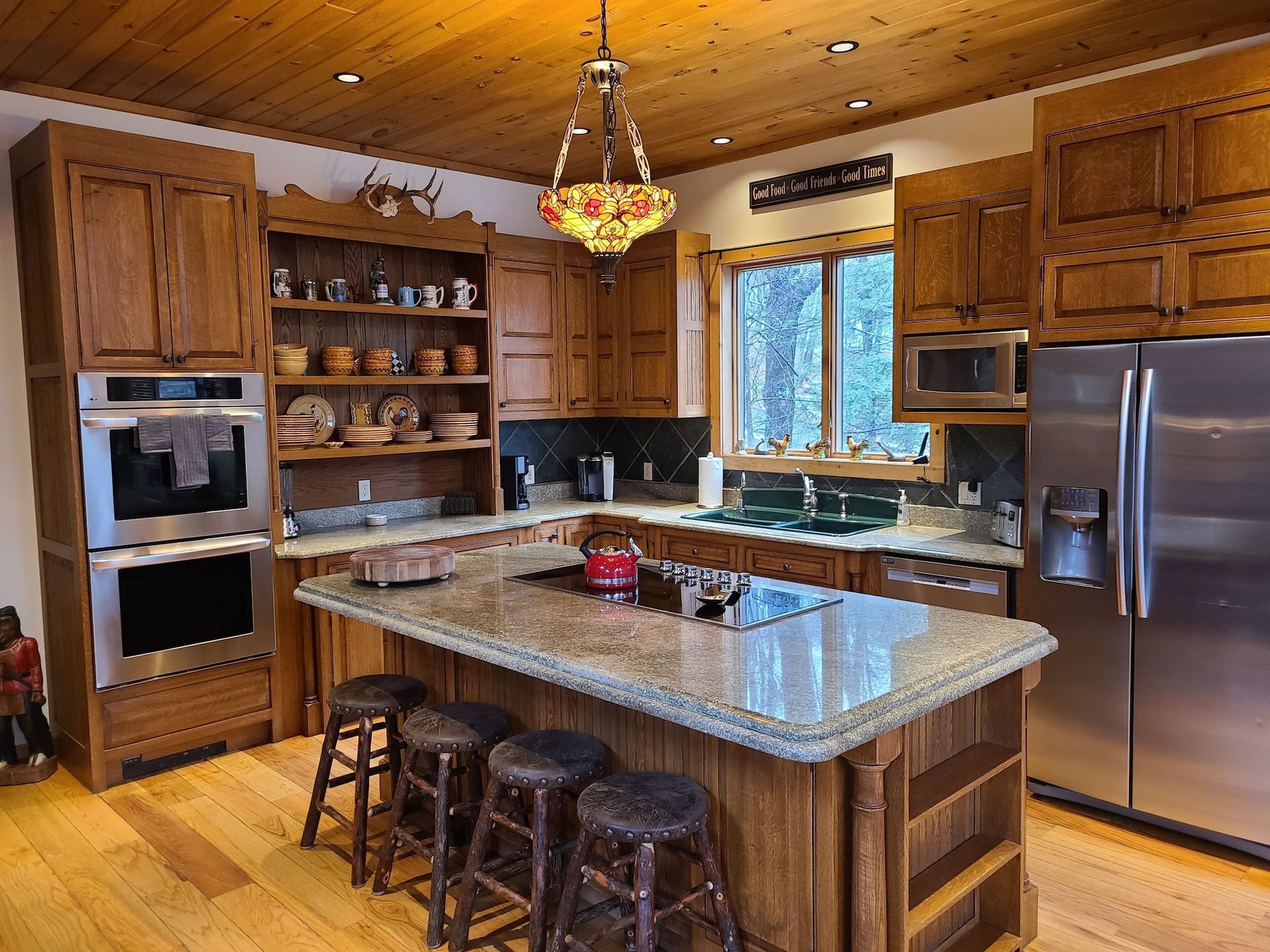 A kitchen with stainless steel appliances and wooden cabinets