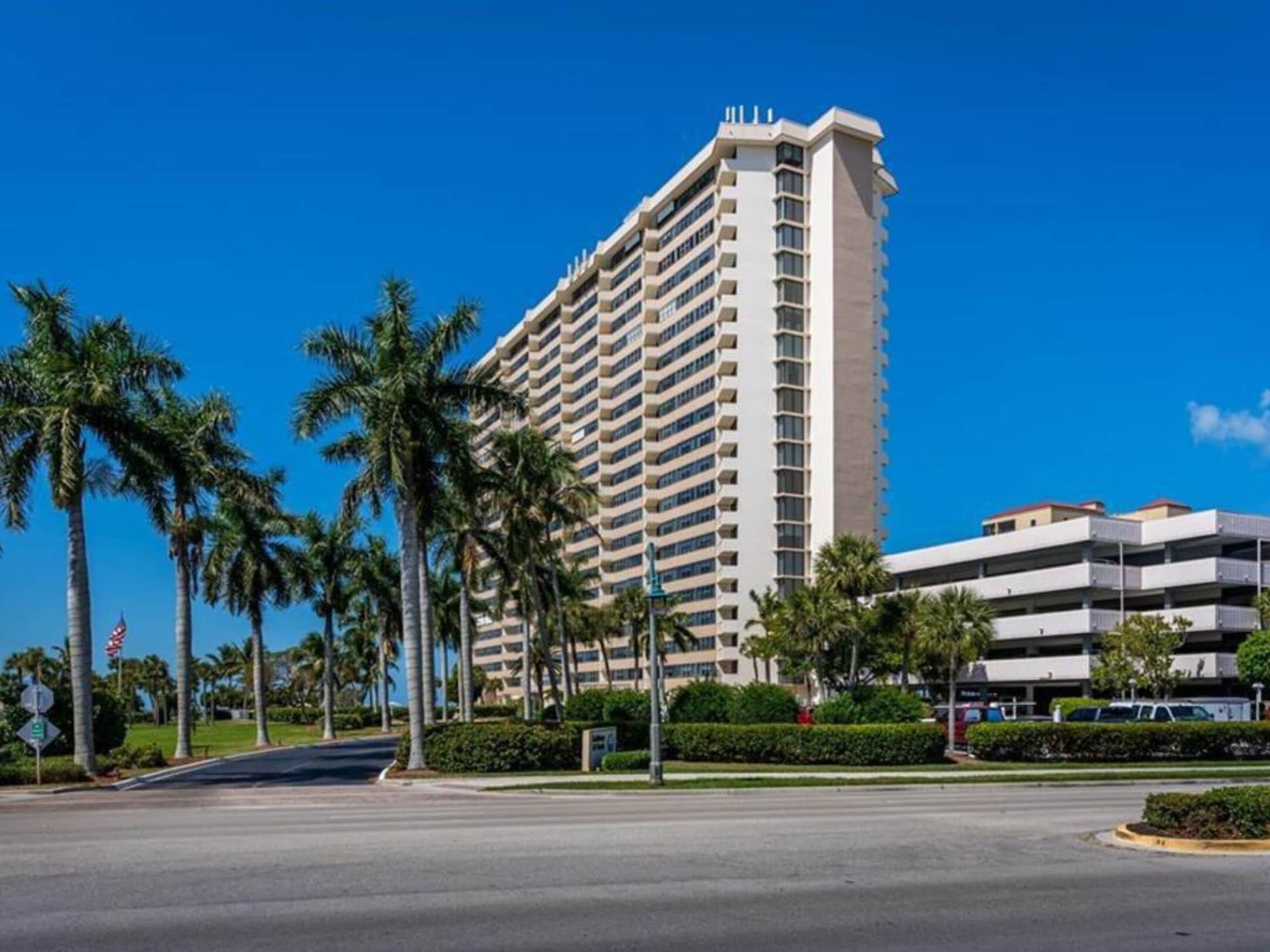 A tall building with palm trees in front of it