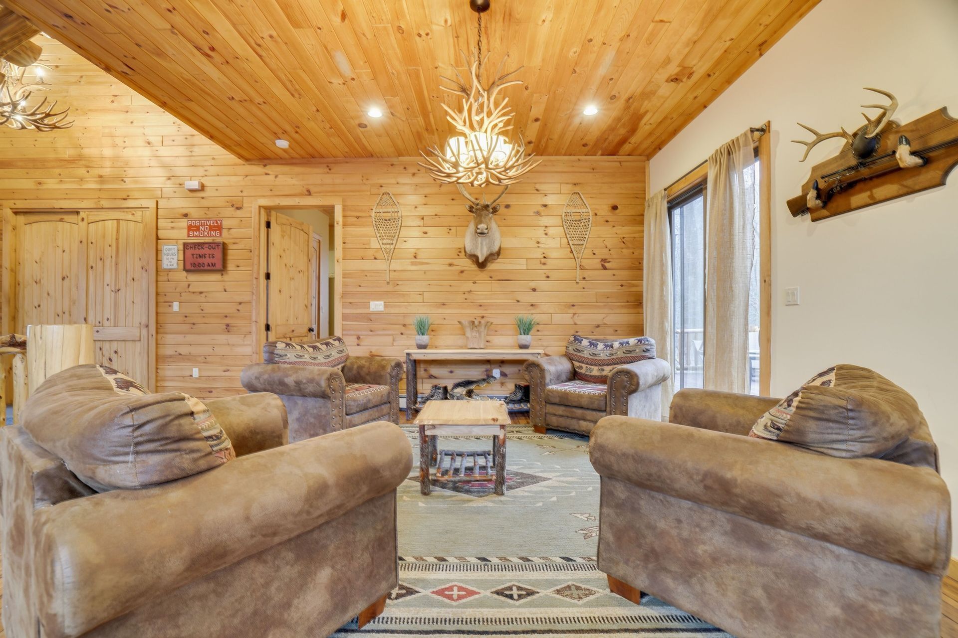 A living room filled with furniture and a wooden ceiling.