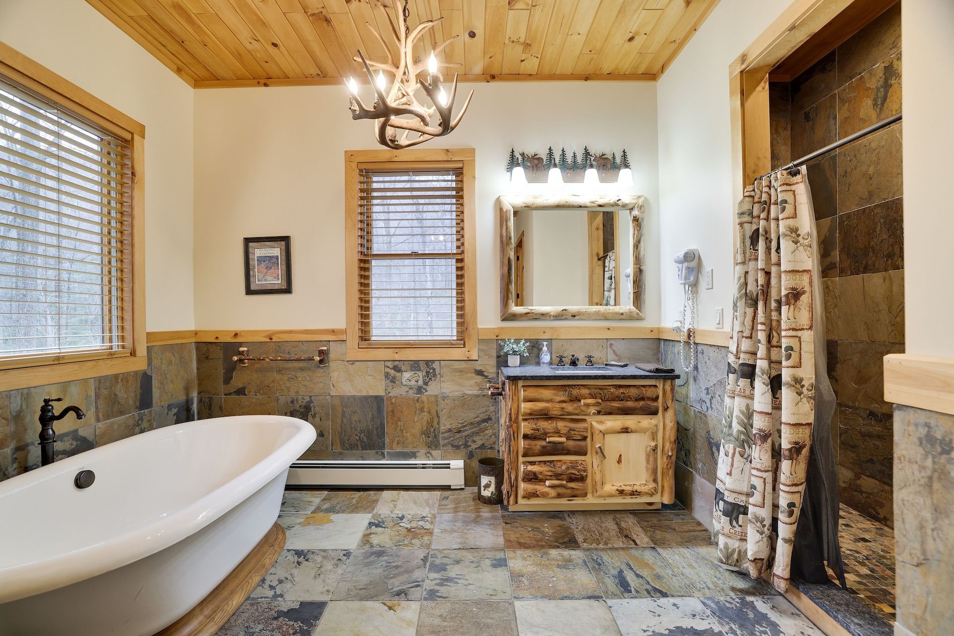 A bathroom with a tub , sink and mirror