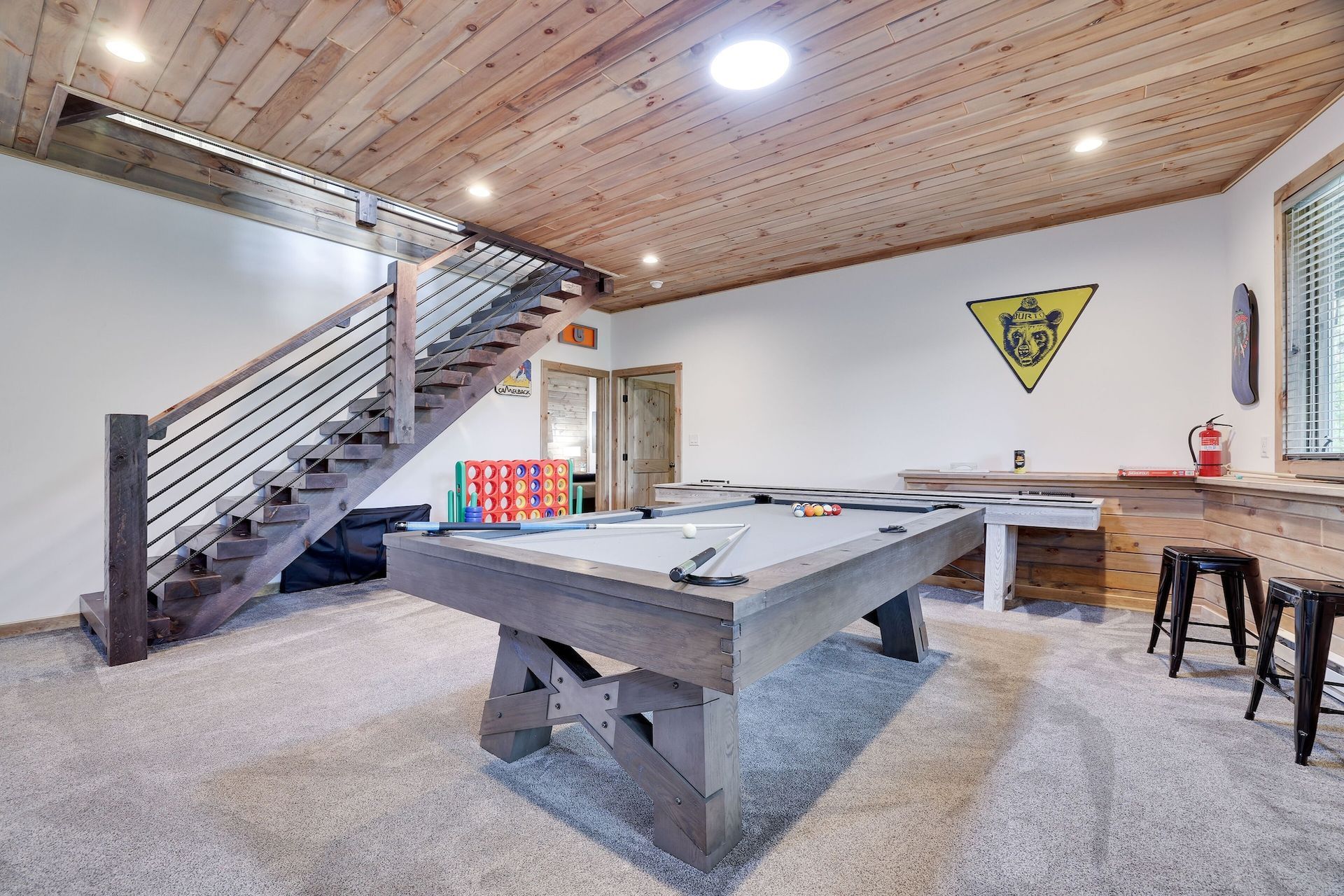 There is a pool table in the middle of the room.