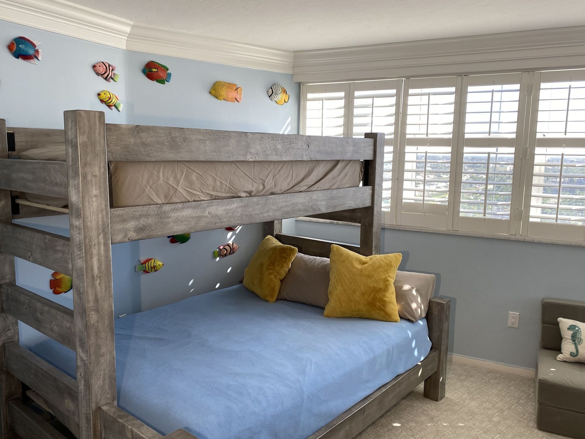 A bedroom with a bunk bed and a couch