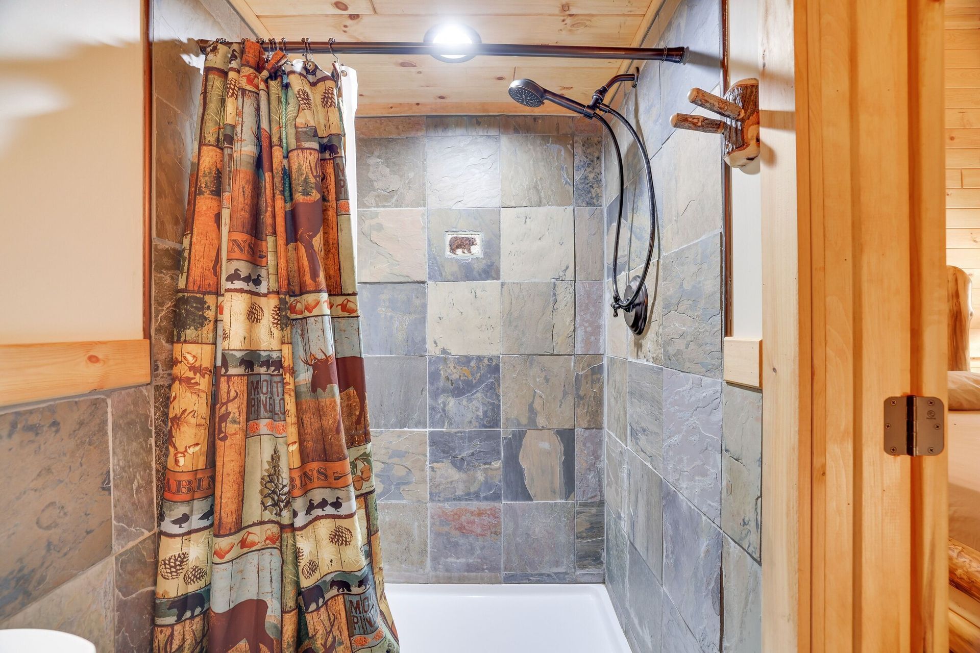 A bathroom with a shower curtain and a toilet.
