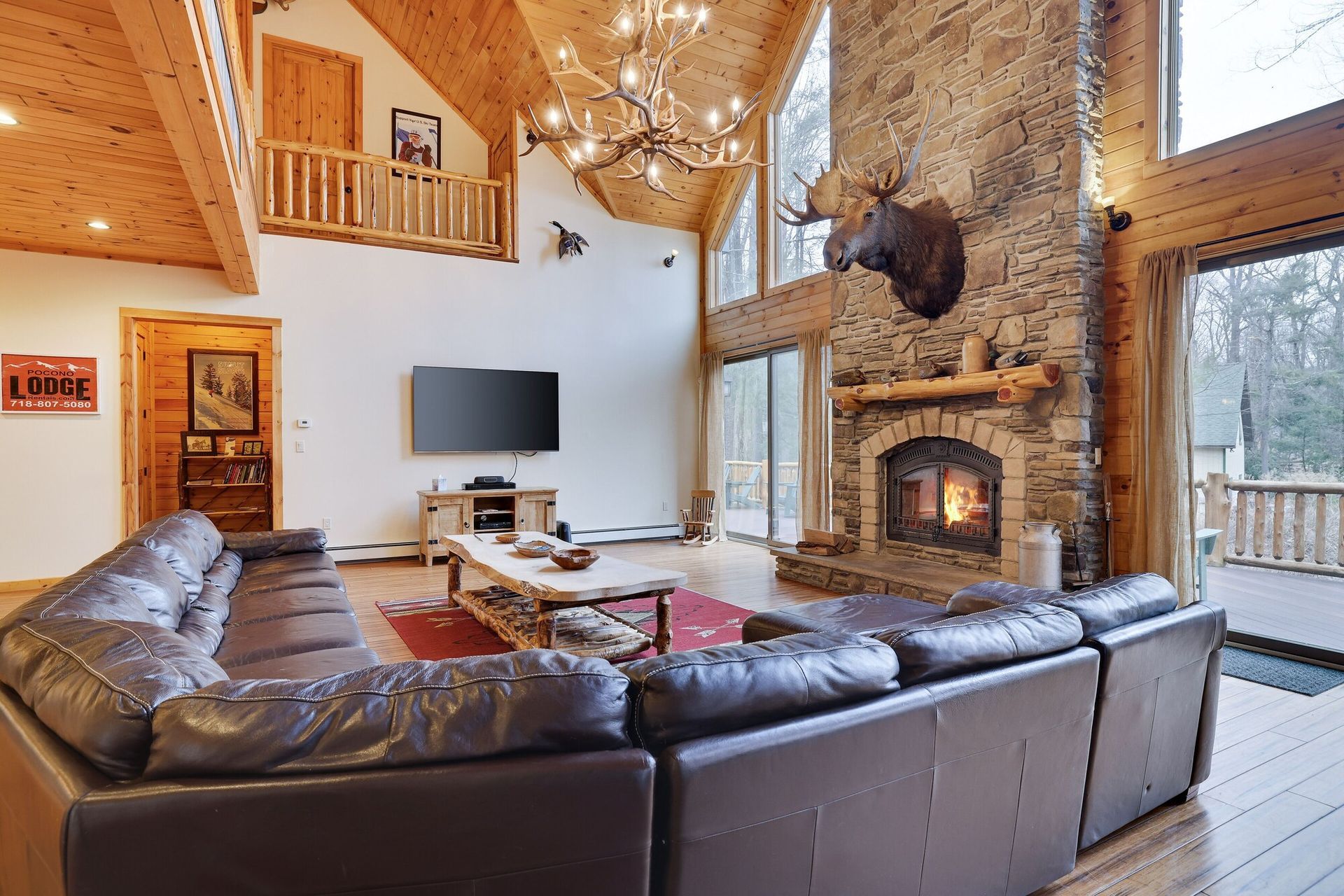 A large house with a large stone chimney and a large deck