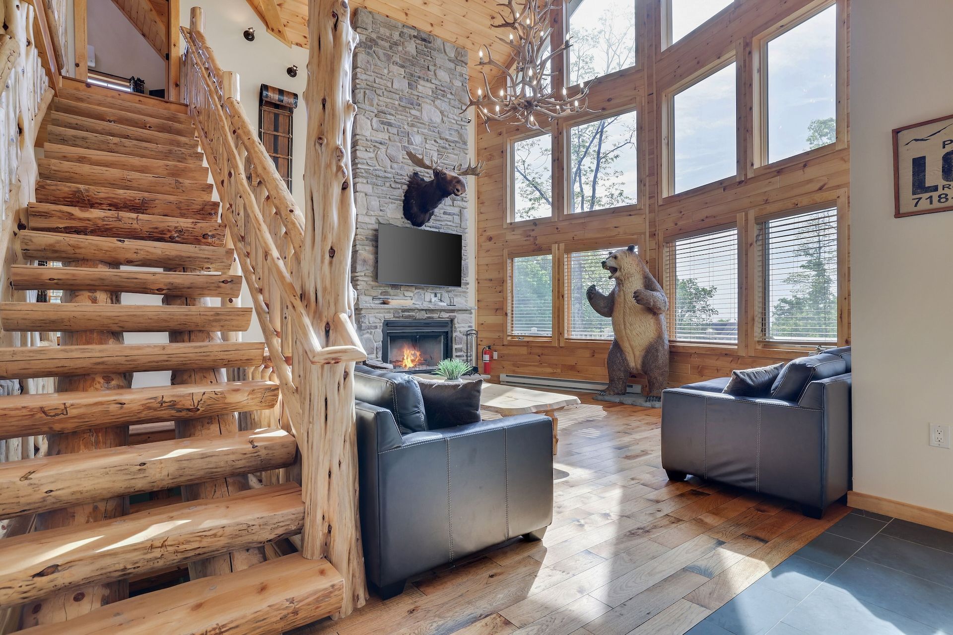 A living room with a wooden staircase leading up to the second floor.