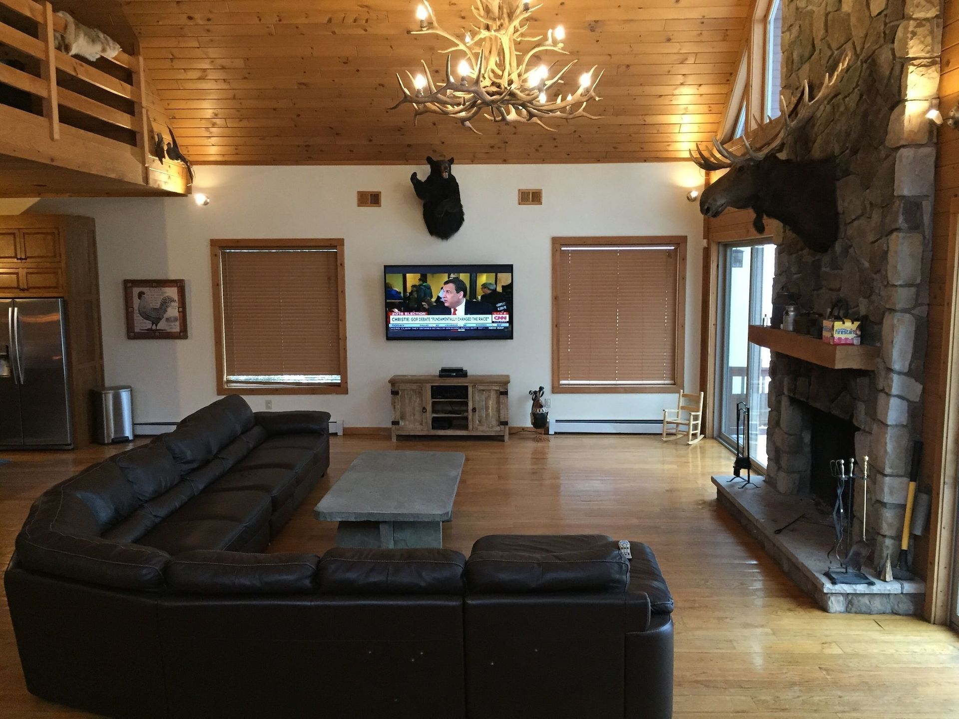 A living room with a couch a television and a fireplace