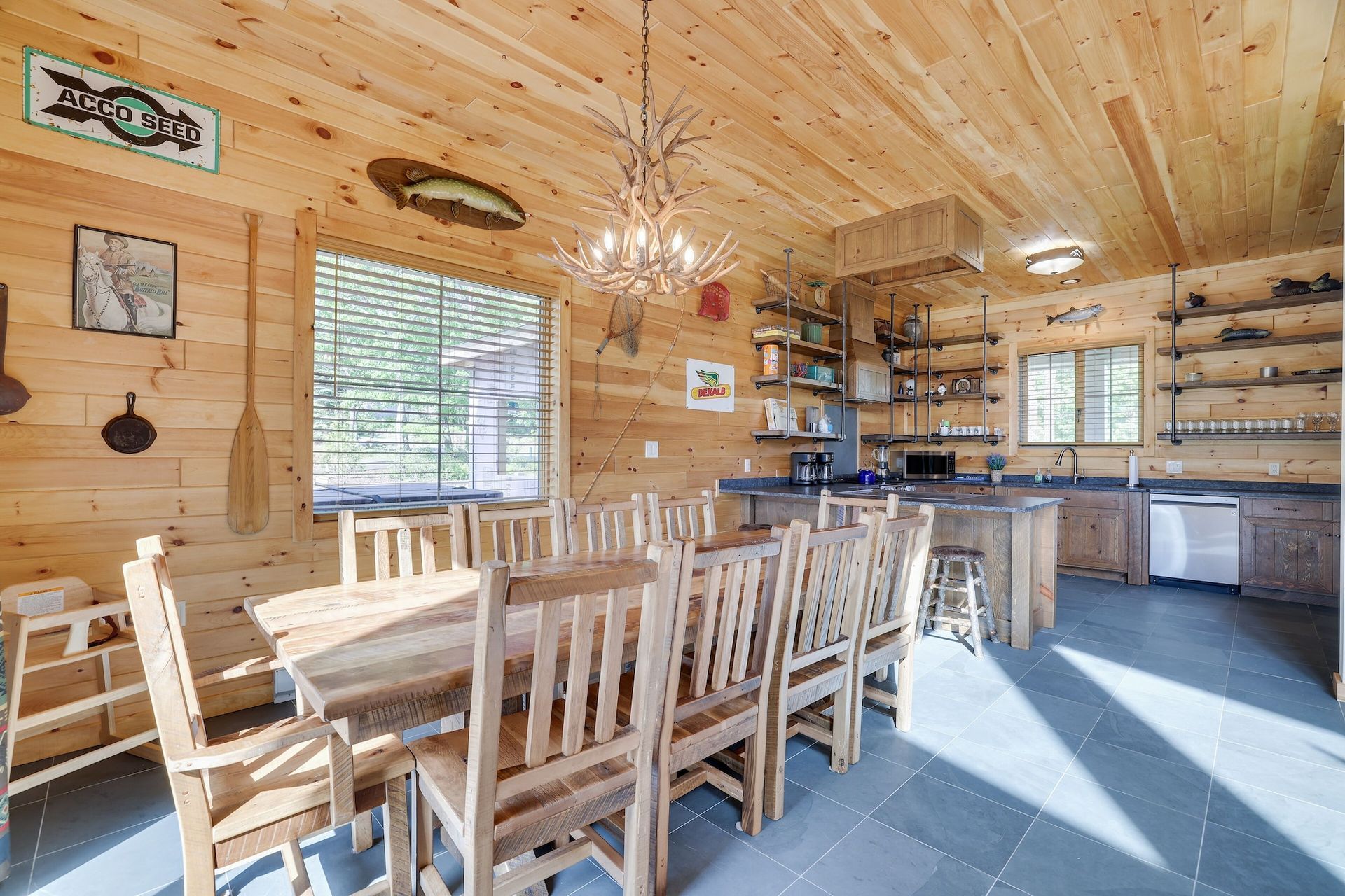 A large wooden dining room table and chairs in a log cabin.