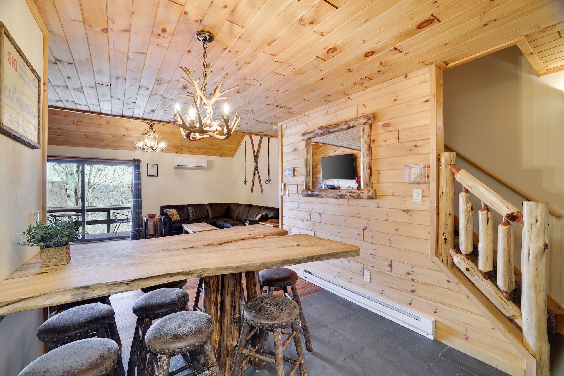 A living room with a wooden table and stools