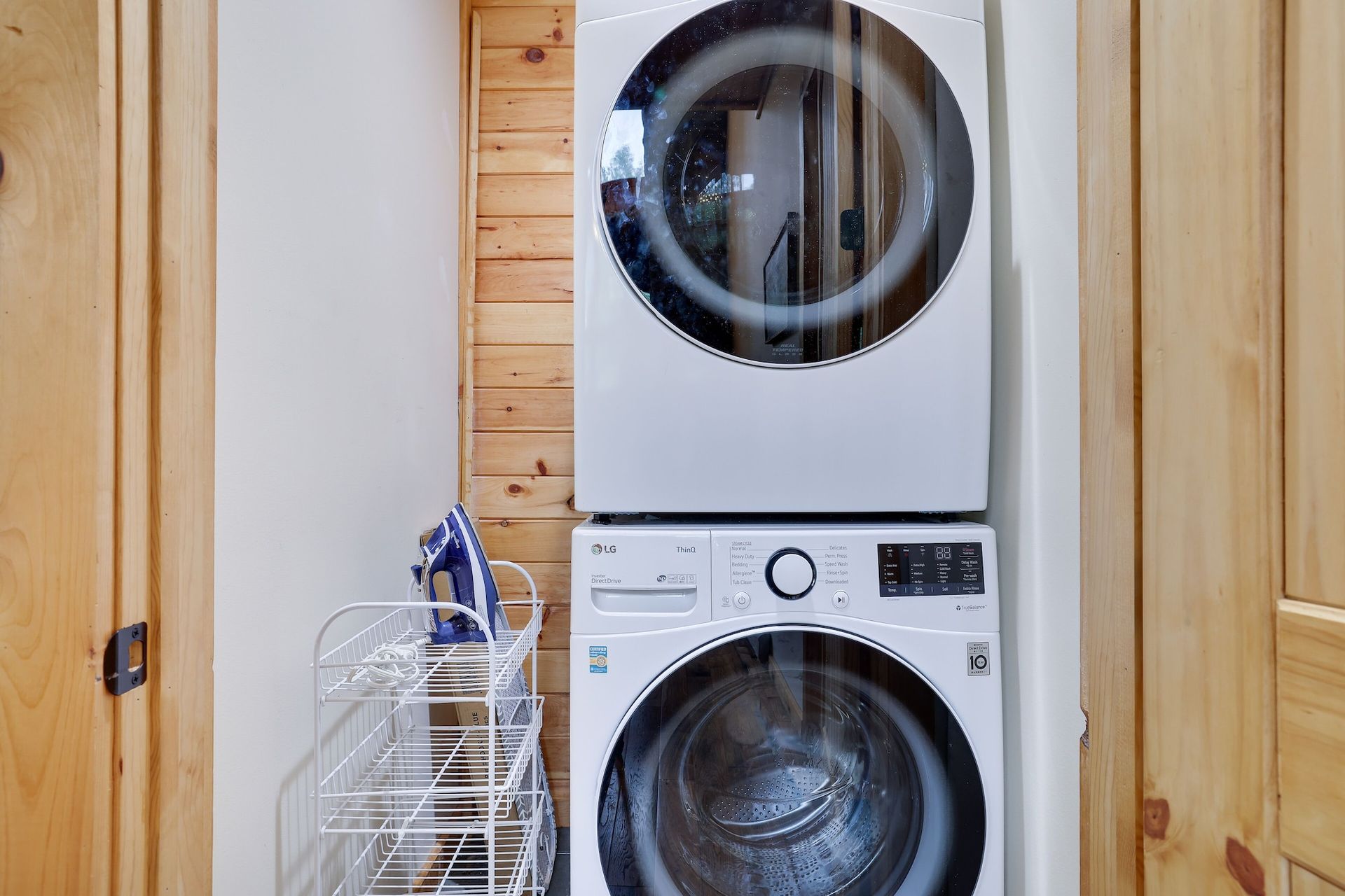 A washer and dryer are stacked on top of each other in a laundry room.