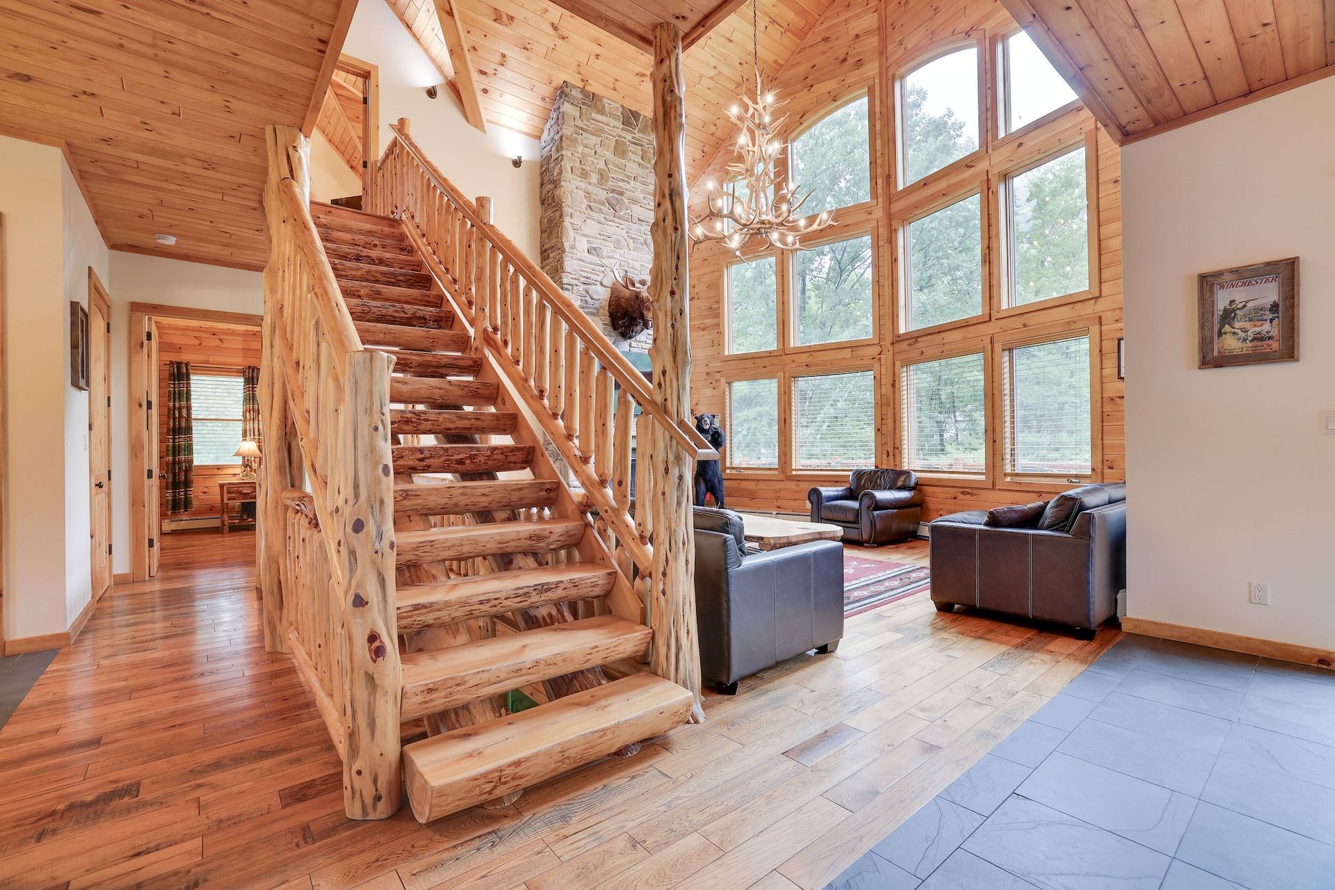 A wooden staircase leading up to the second floor of a log cabin.