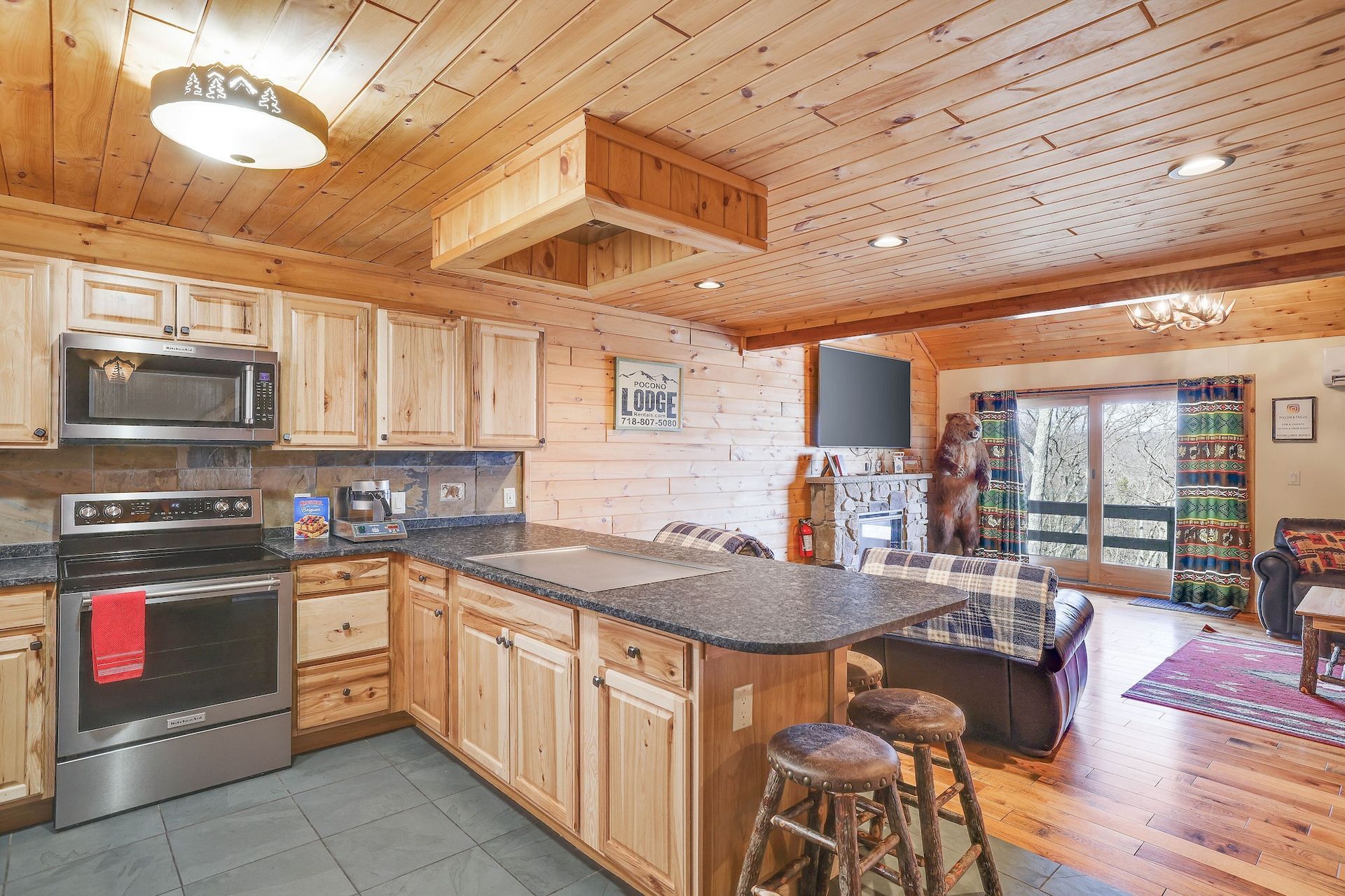 A kitchen in a log cabin with stainless steel appliances