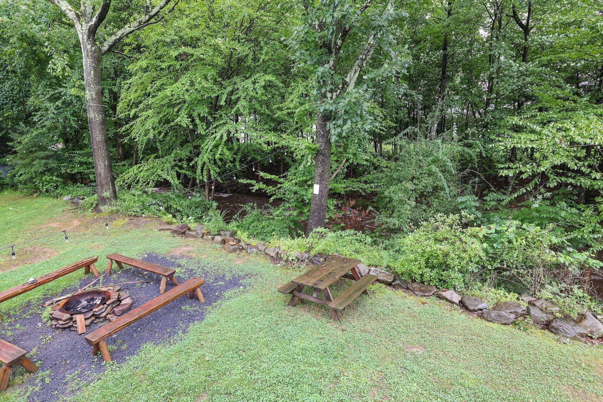 There is a fire pit in the middle of the yard.