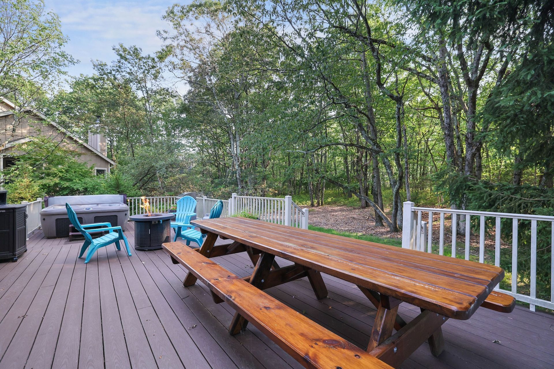 There is a picnic table and chairs on the deck.