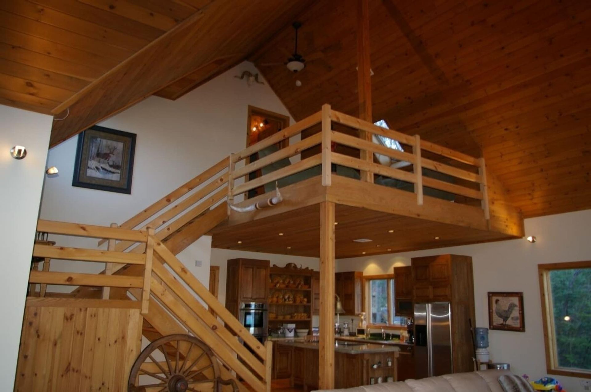 A wooden staircase leading up to a loft in a house