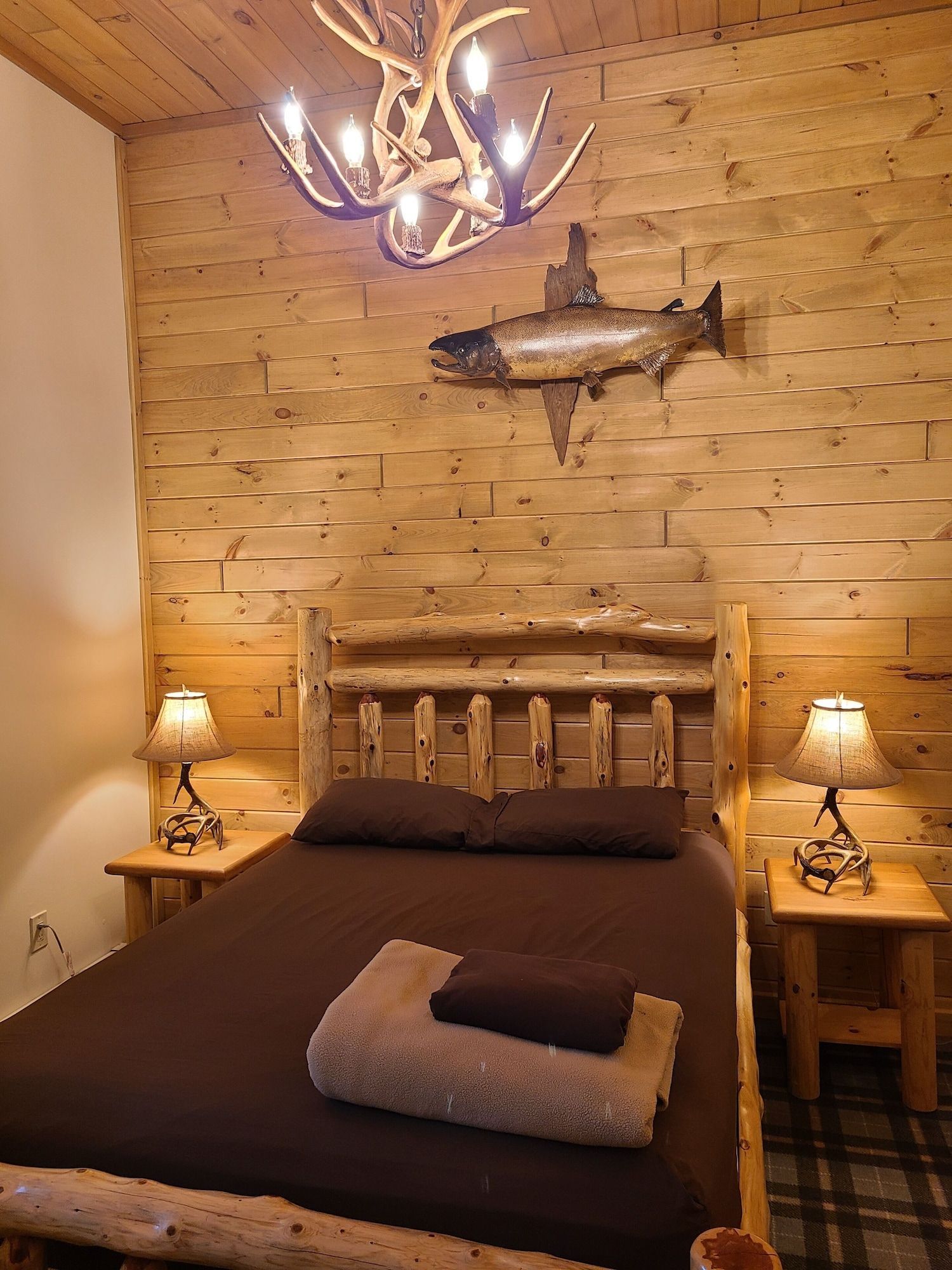 A bedroom with a bed and a fish on the wall