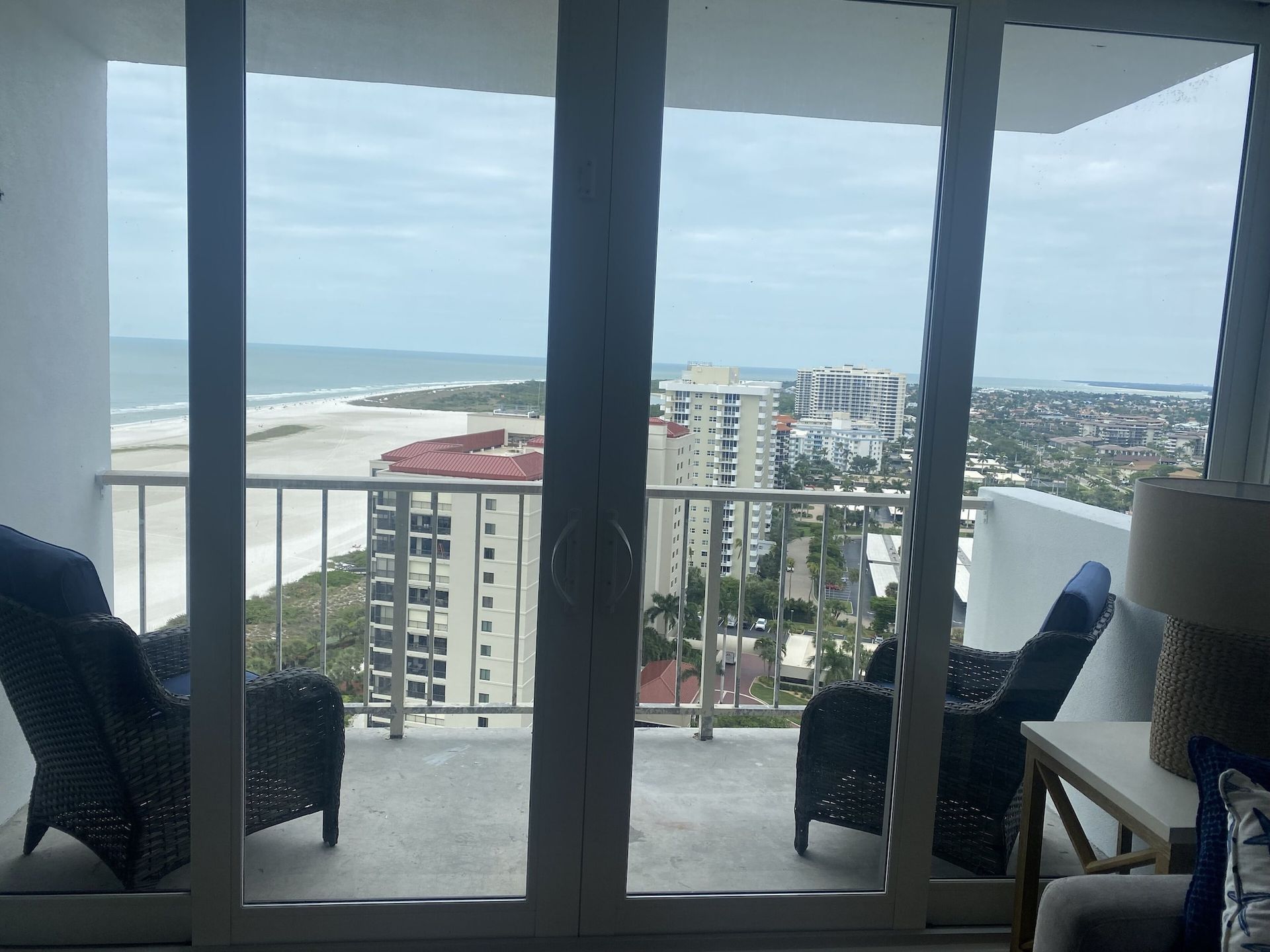 A balcony with a view of the ocean and buildings